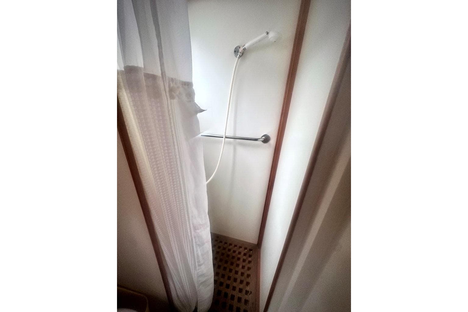 Shower area in 1991 Grand Banks 36 Europa yacht with curtain and handheld showerhead.