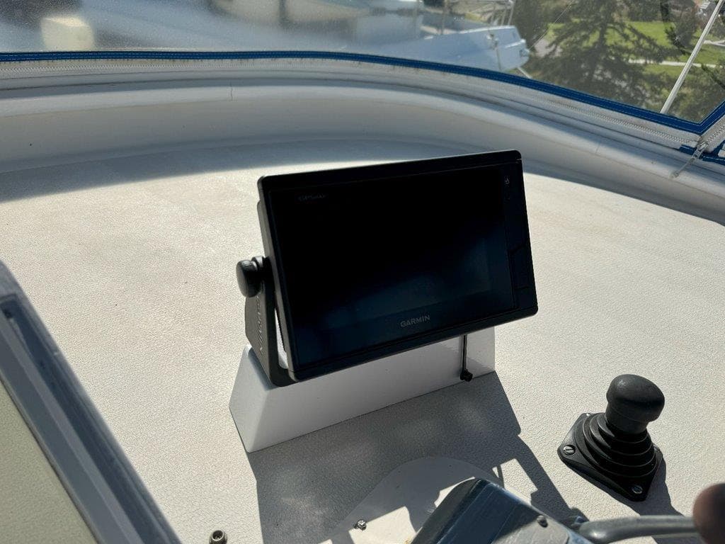 Control panel of 1980 Ocean Alexander 50 MK1 yacht with Garmin display.
