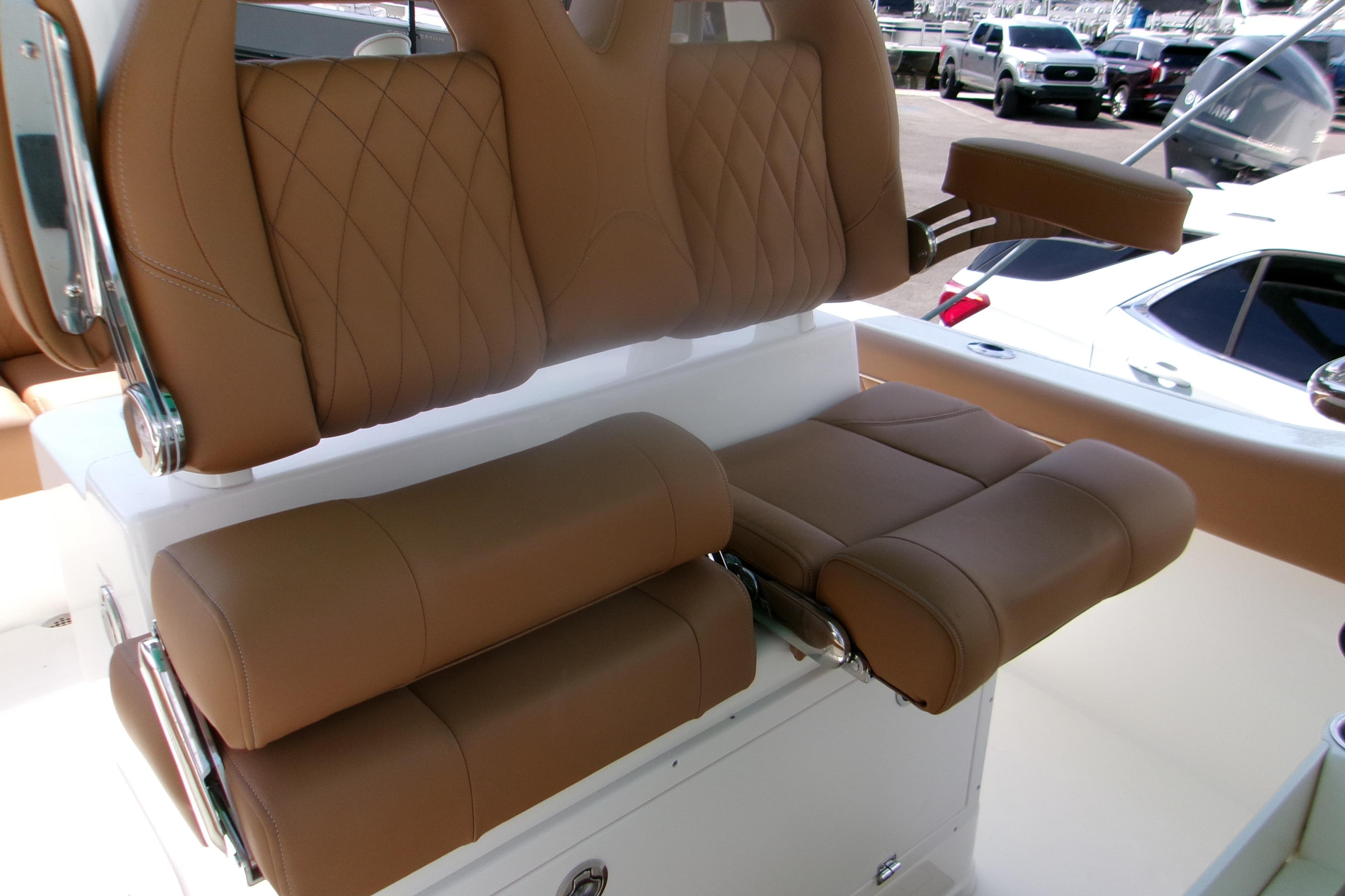 Luxurious seating on 2027 Key West 249 FS boat with tan upholstery and armrests.