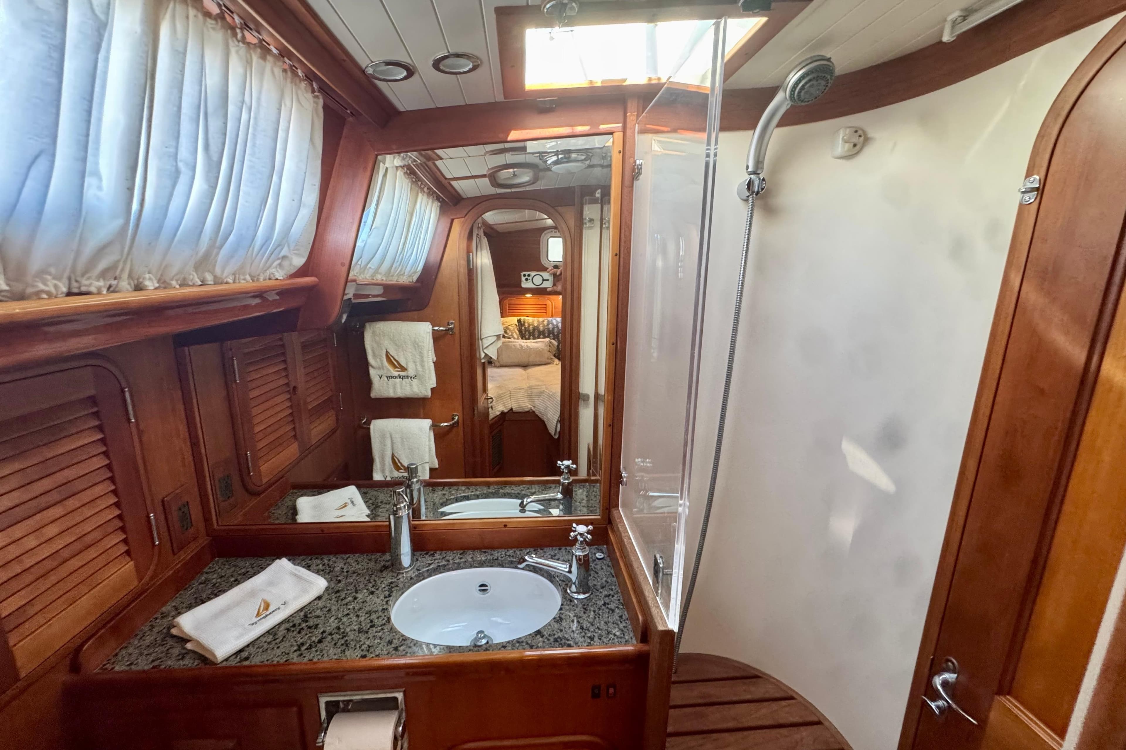 Luxurious 1999 Hinckley Sou'wester 52 yacht bathroom with wood accents and modern fixtures.