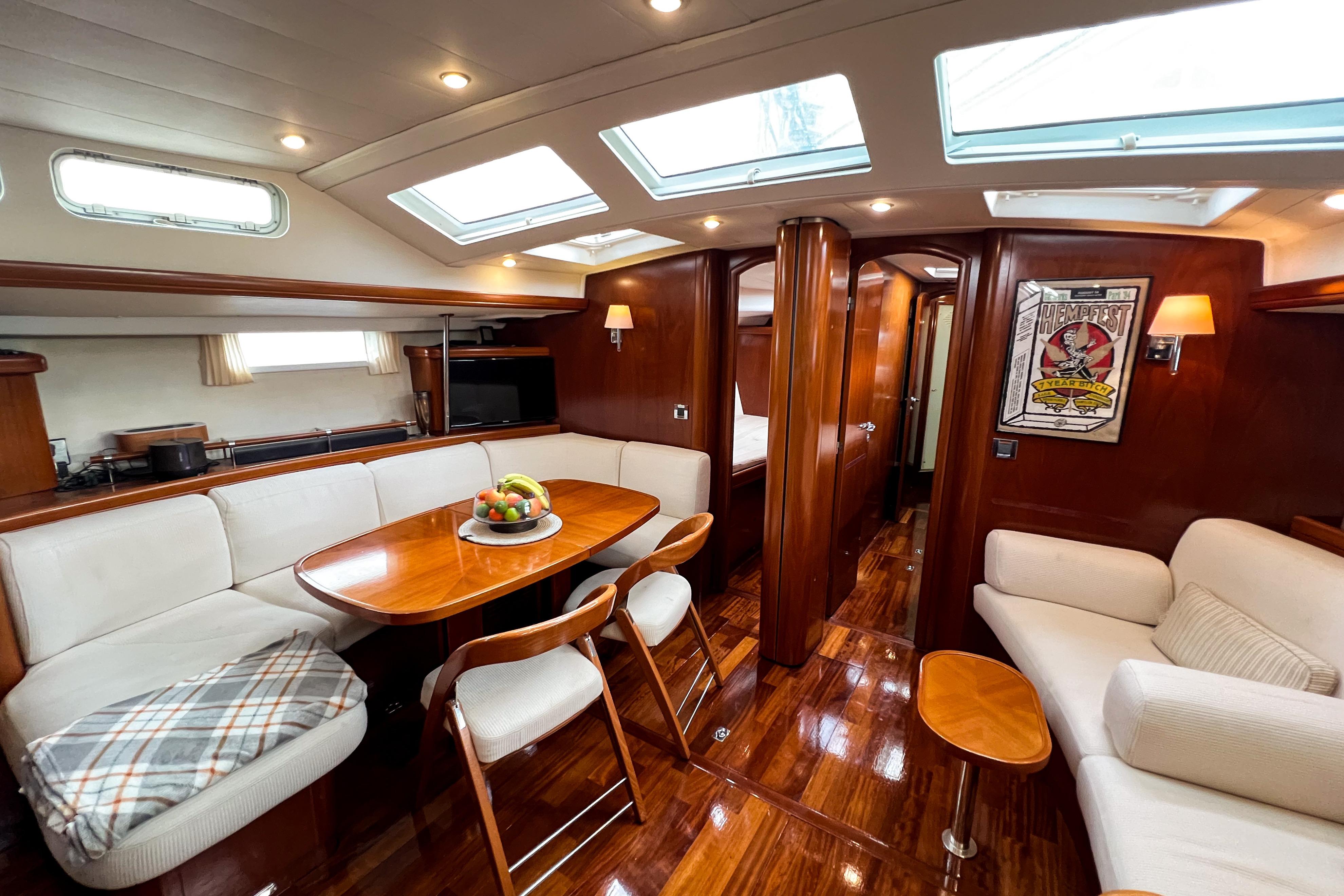 Luxurious interior of 2004 Beneteau 57 yacht with elegant wood finish and skylights.