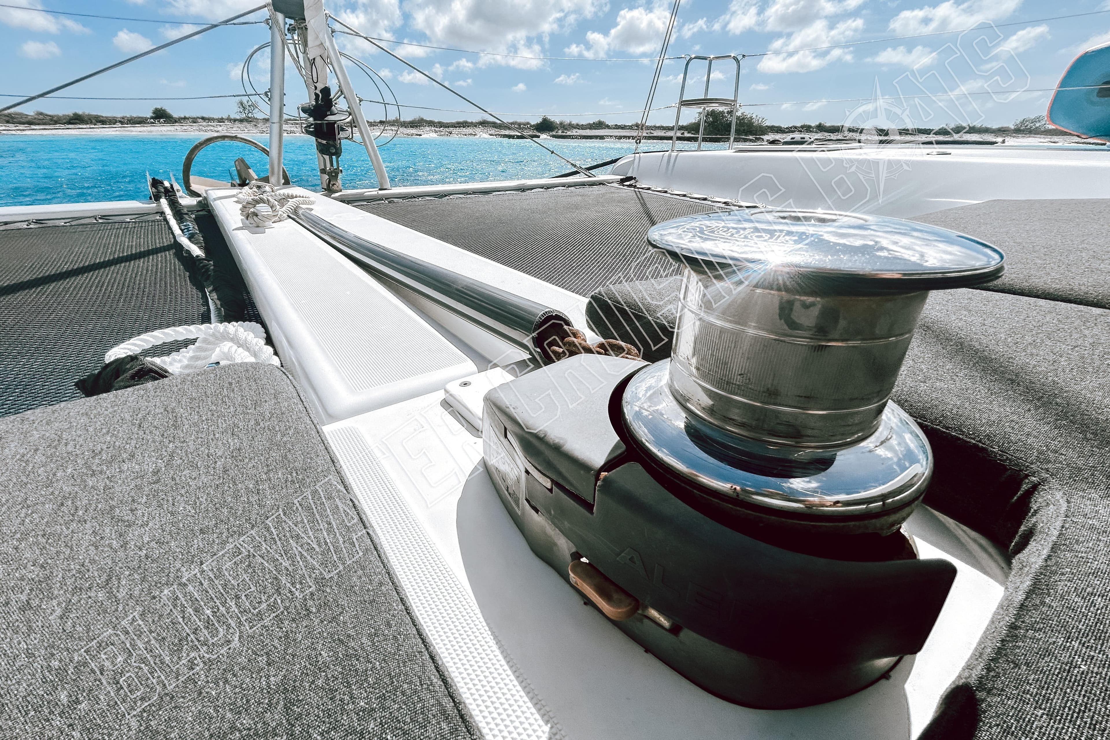 2018 Lagoon 42 catamaran deck with winch, sailing in clear blue waters.