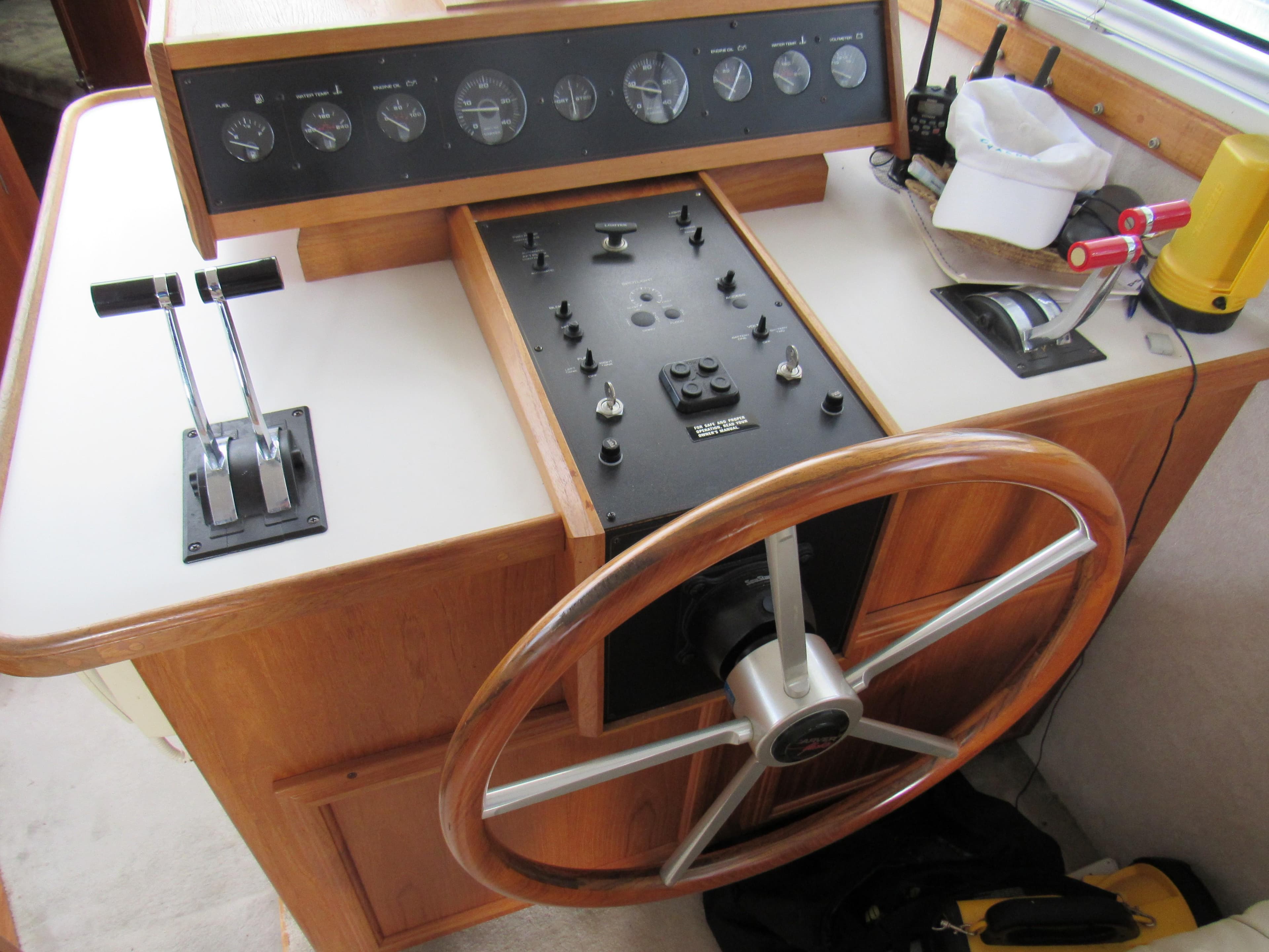 1991 Carver 430 Cockpit Motor Yacht helm with wooden steering wheel and control panel.