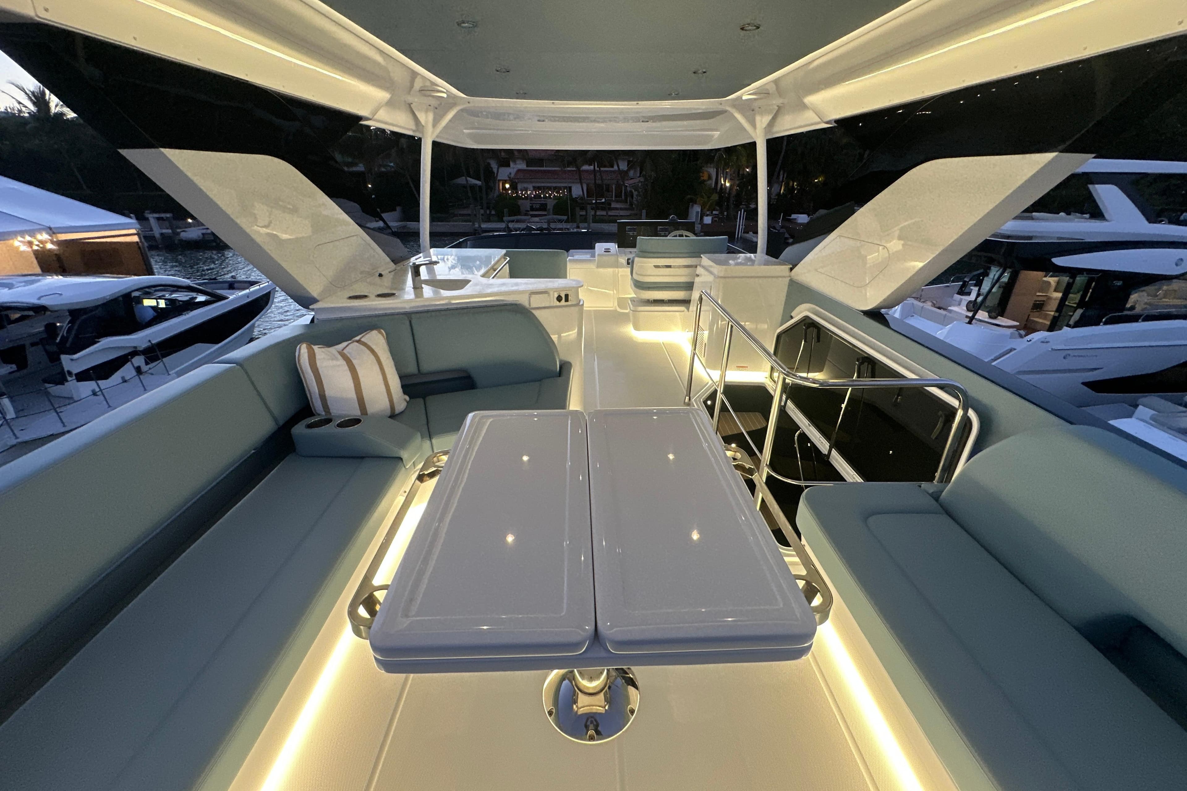 Luxurious 2026 Cruisers Yachts 57 Fly interior with elegant seating and ambient lighting.