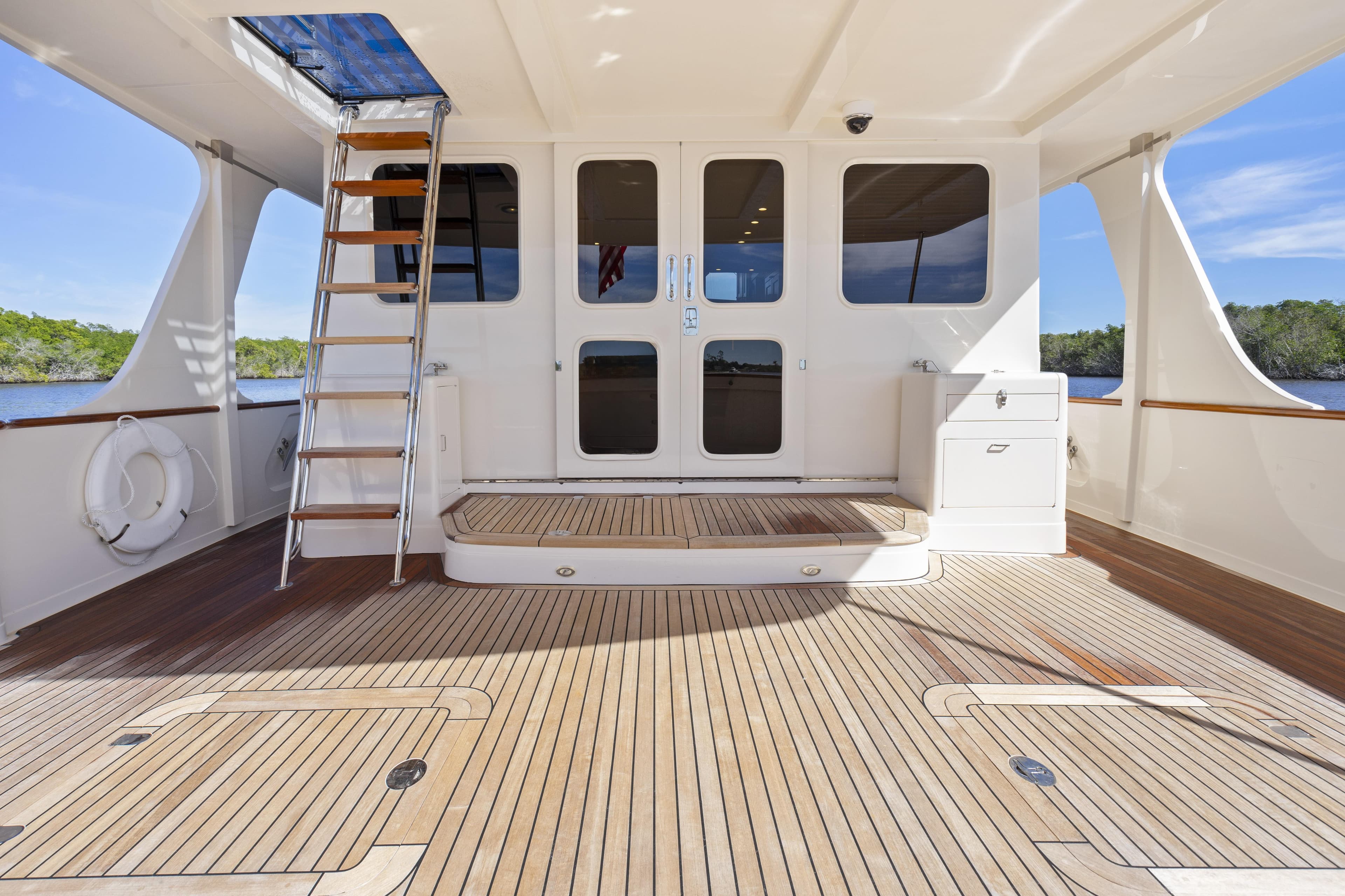 Spacious deck of 2023 Fleming 65 yacht with wooden flooring and modern design.