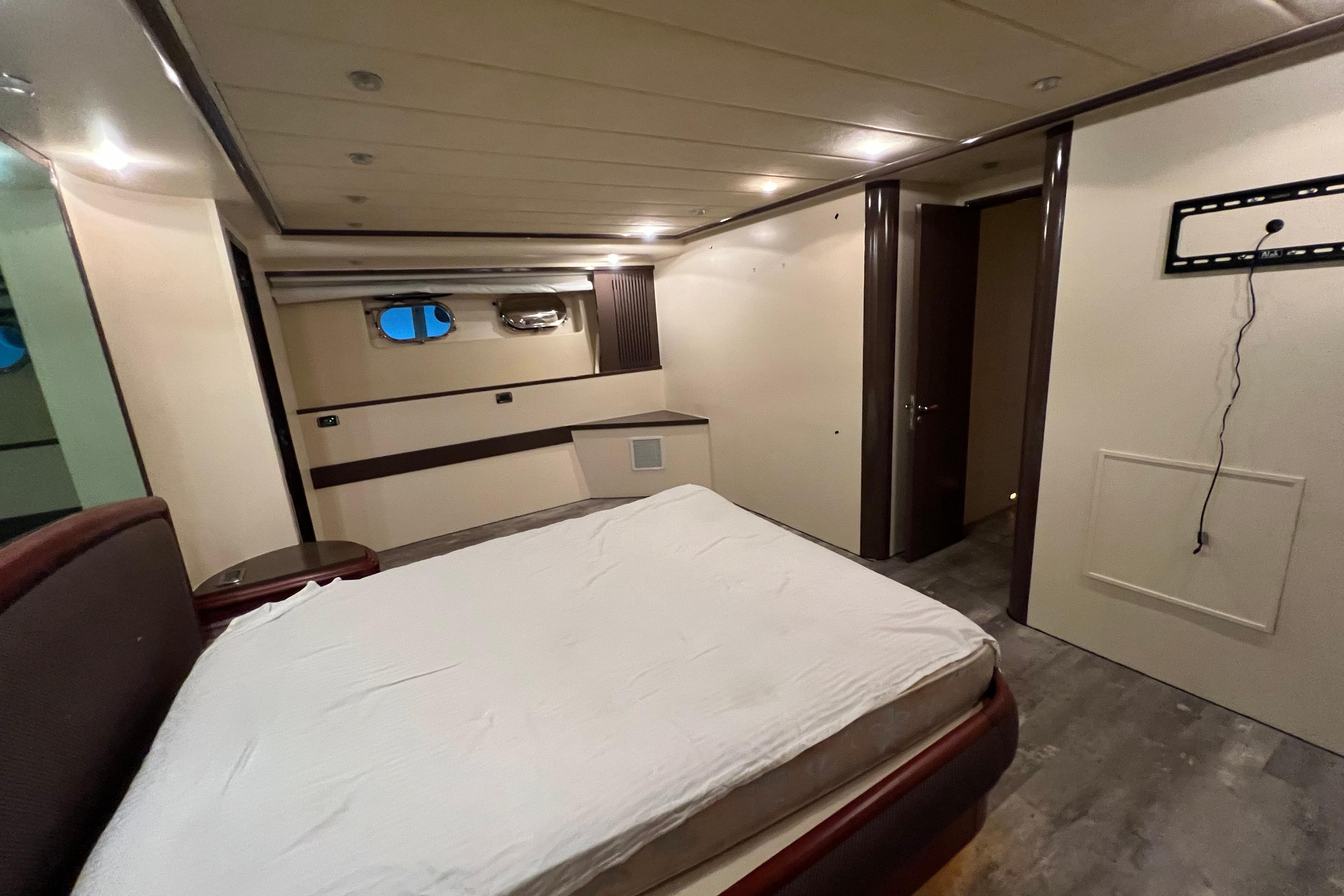 Luxurious bedroom interior of 2001 Falcon 106 yacht with modern design elements.