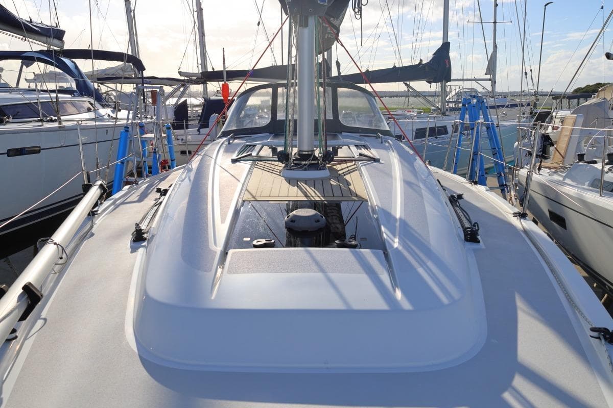 2018 Dehler 34 sailboat deck view in marina, surrounded by other yachts.