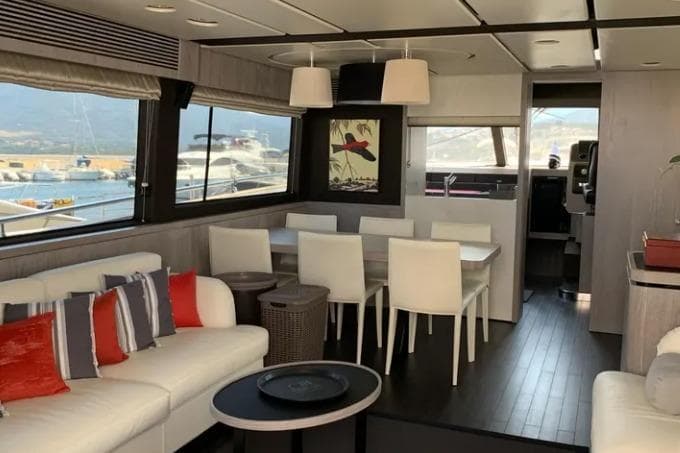 Luxurious interior of 2019 Azimut Magellano 66 yacht with modern dining and seating area.