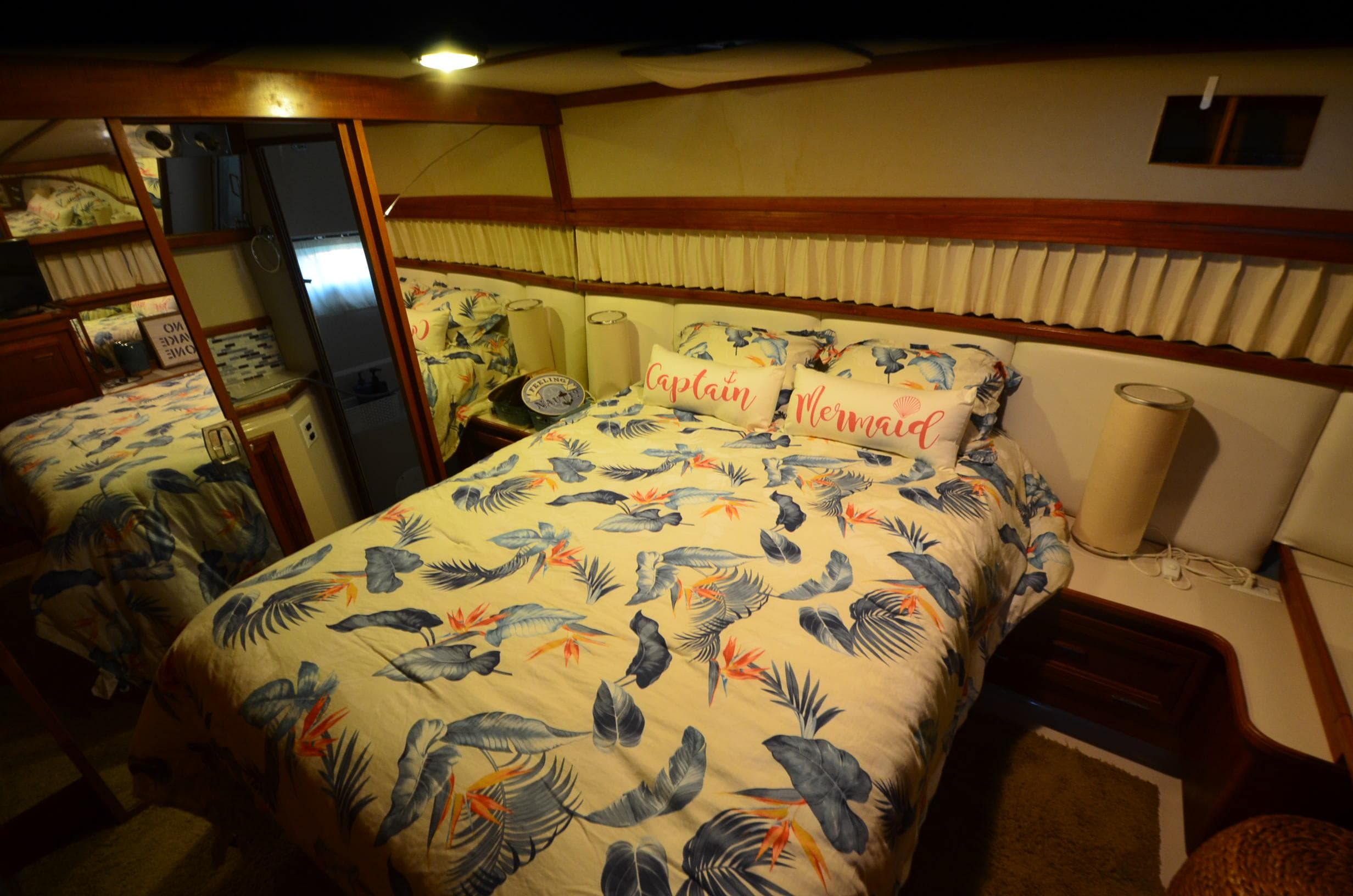 1988 Carver 4207 Aft Cabin MY bedroom with tropical bedding and decorative pillows.