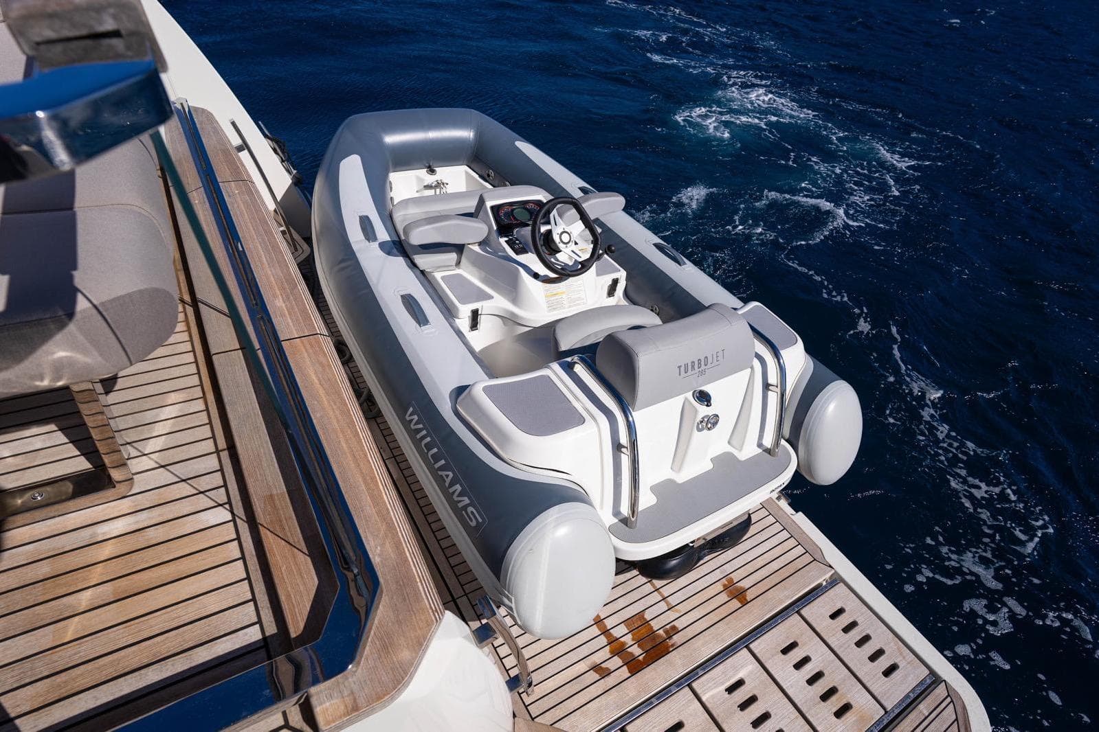 2023 Prestige X60 yacht with Williams Turbojet tender on deck, ocean backdrop.