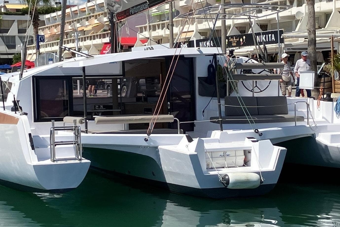 2024 NEEL 43 trimaran docked at marina, showcasing modern design and spacious deck.