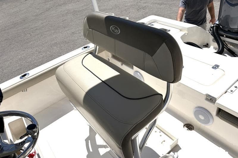 2024 Key West 210 Bay Reef boat interior with cushioned seating and steering wheel.
