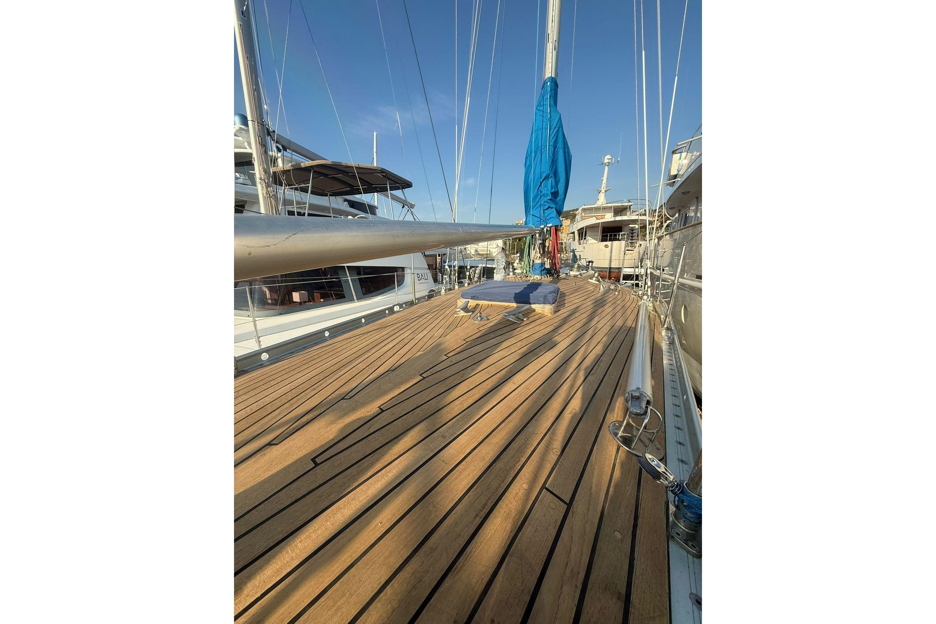 Deck of 1974 Nautor Swan 41 sailboat with wooden finish and blue sail cover.
