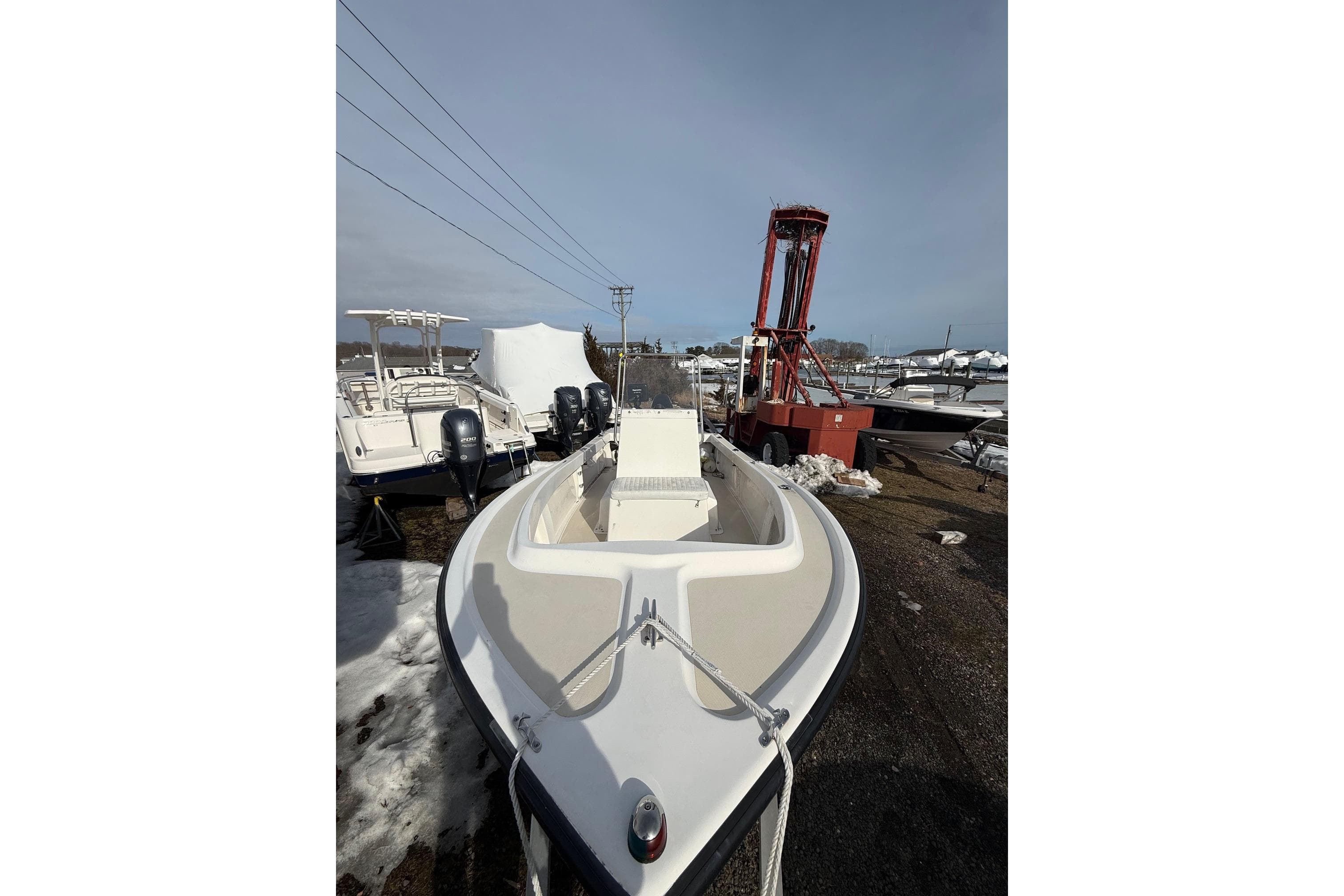 2018 NorthCoast 190 Center Console boat in storage yard, surrounded by snow.