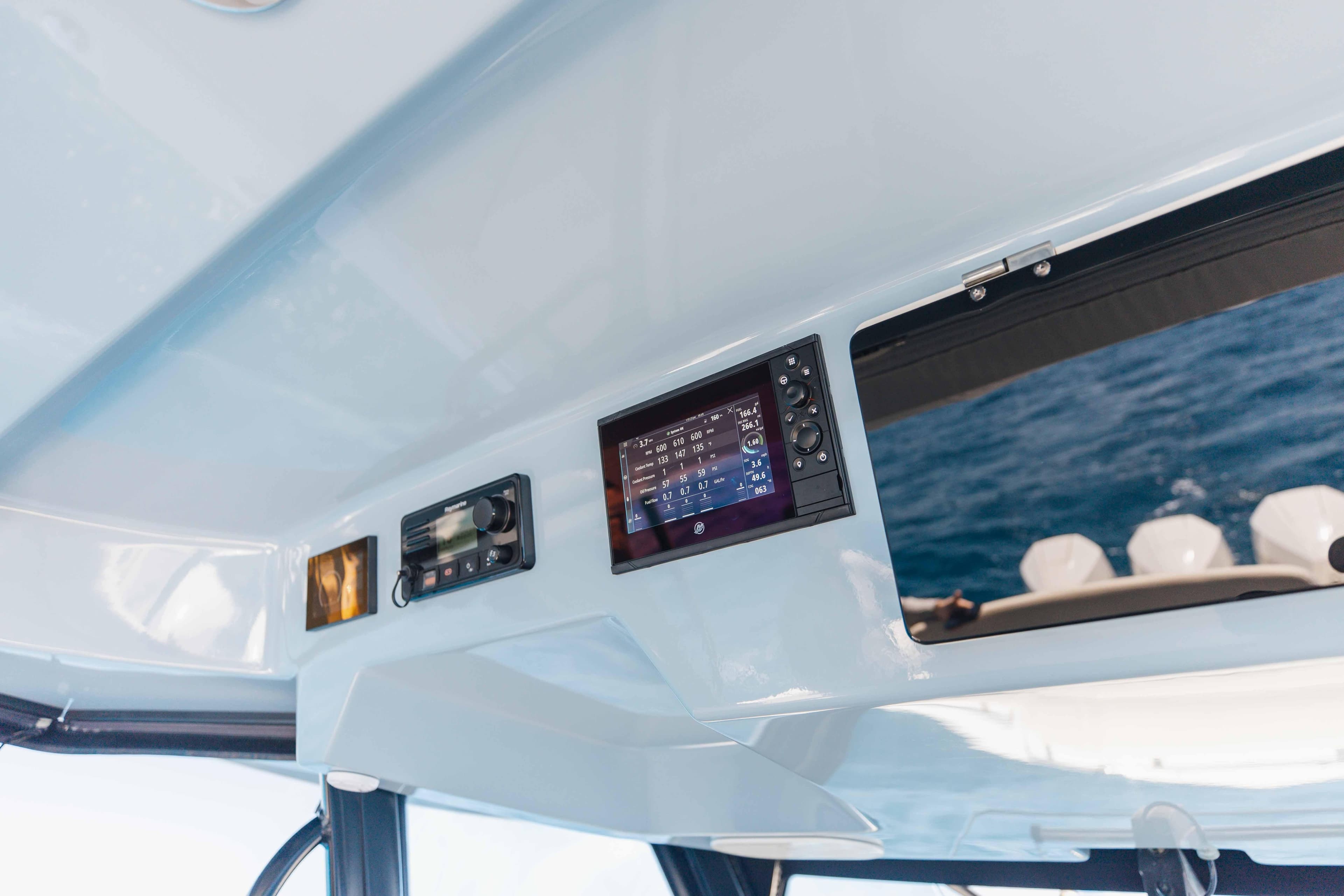 2021 Boston Whaler 350 Realm dashboard with navigation display and controls, overlooking the ocean.