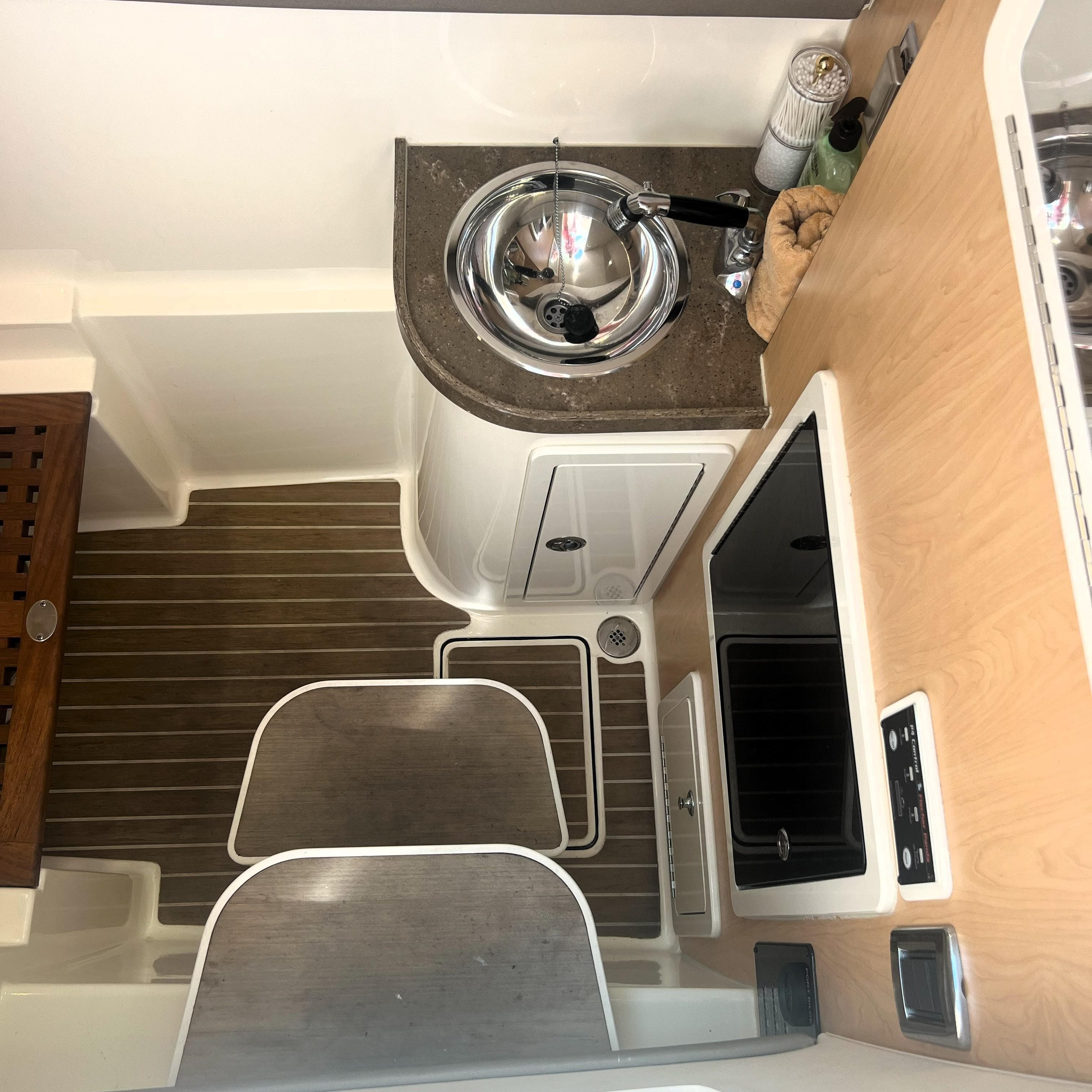2016 World Cat 320 DC interior with sink, stove, and wooden flooring.