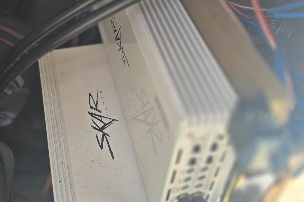 Skar Audio amplifier in a 2012 Yamaha Boats 242 Limited S, surrounded by wiring.