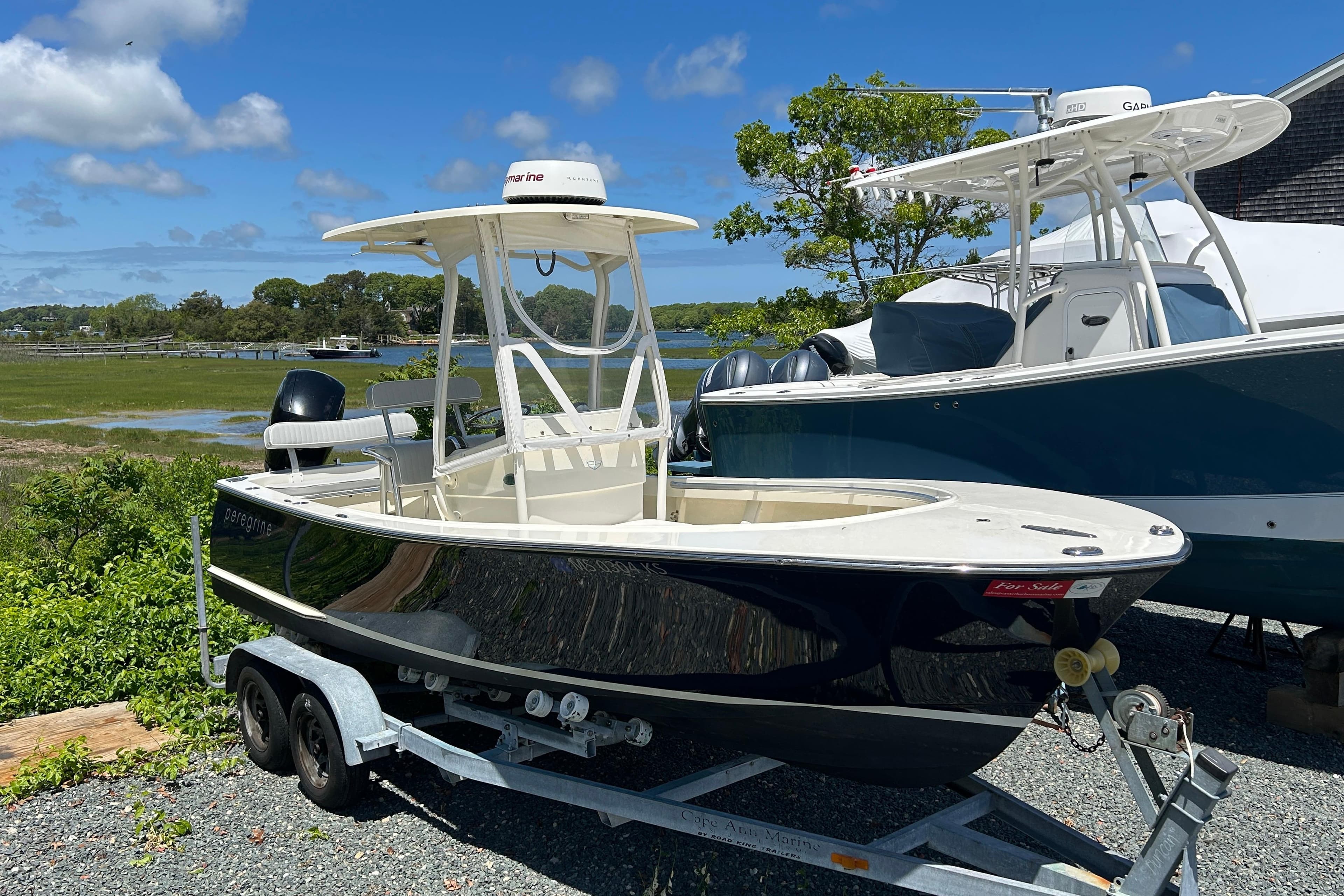 2004 Gloucester G-20 boat on trailer, parked outdoors under clear blue sky.