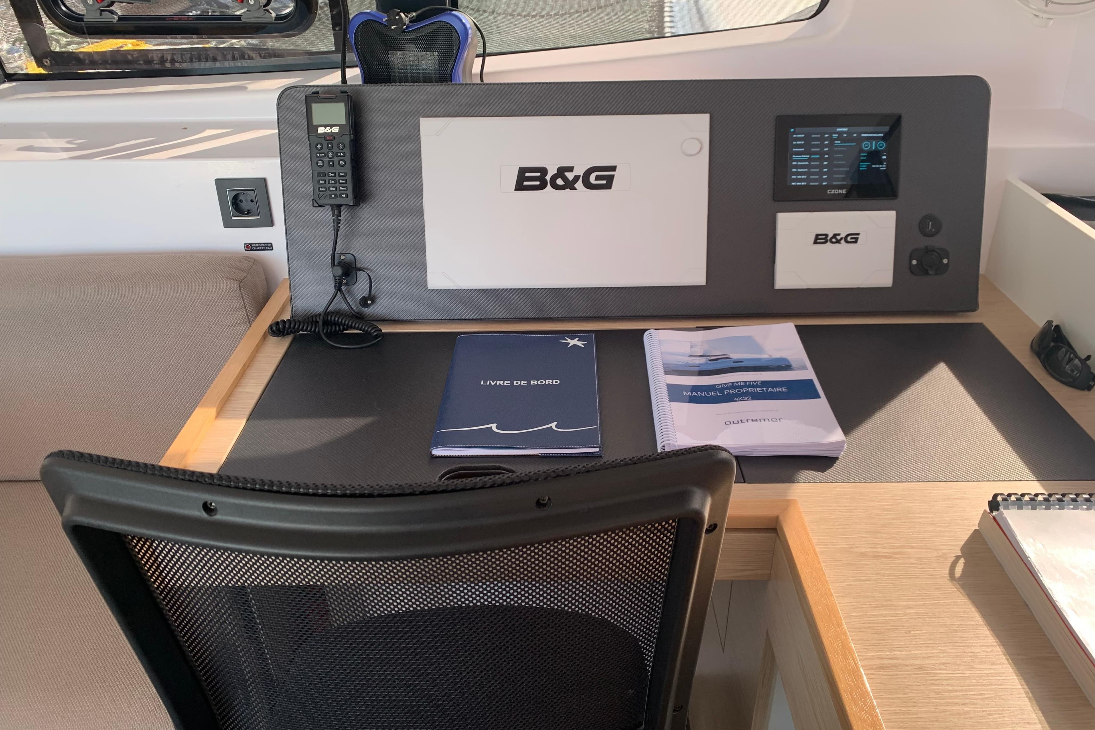 Navigation station in 2025 Outremer 4X catamaran with B&G equipment and manuals.