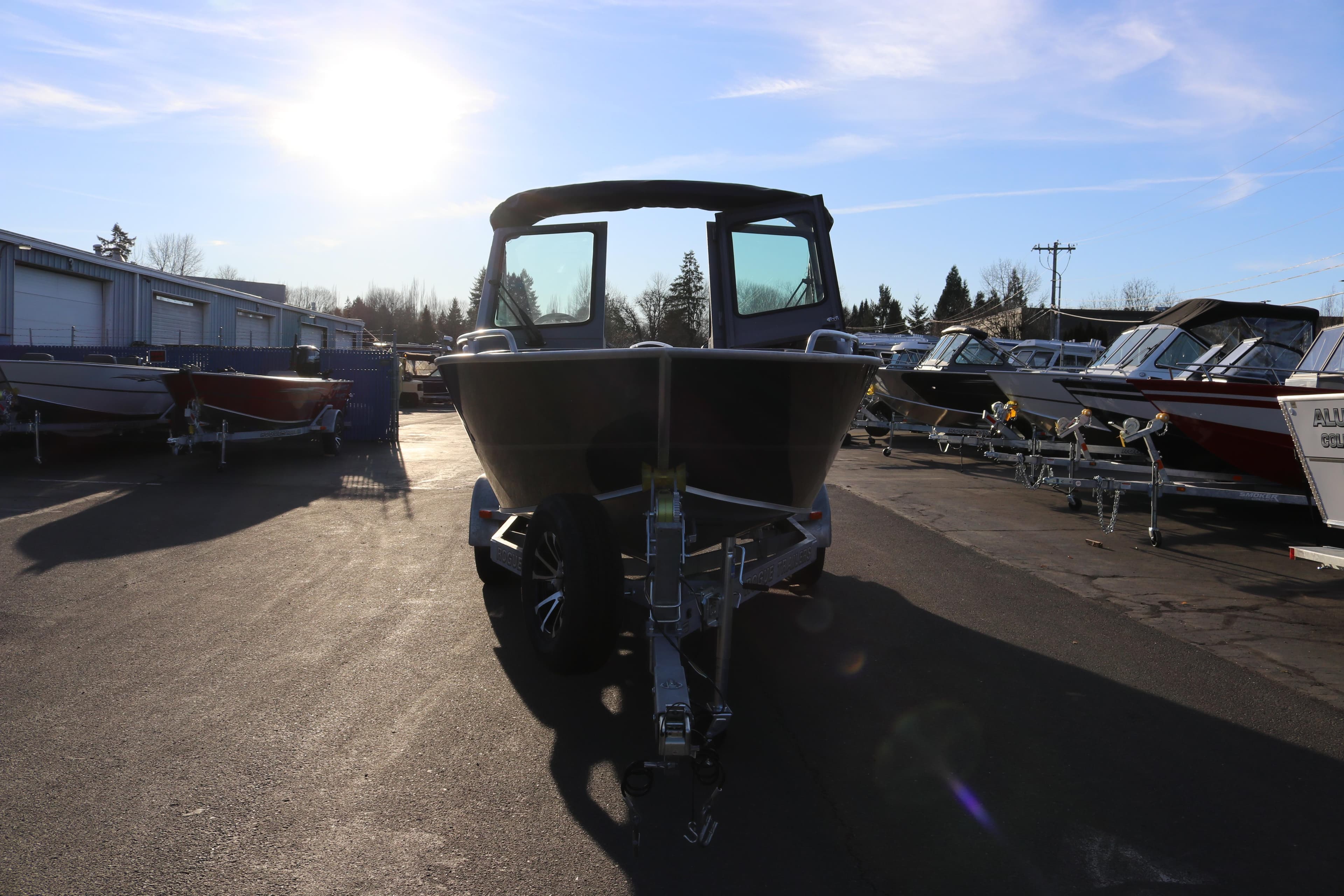 2026 Alumaweld Stryker 220 boat on trailer in sunny outdoor lot.