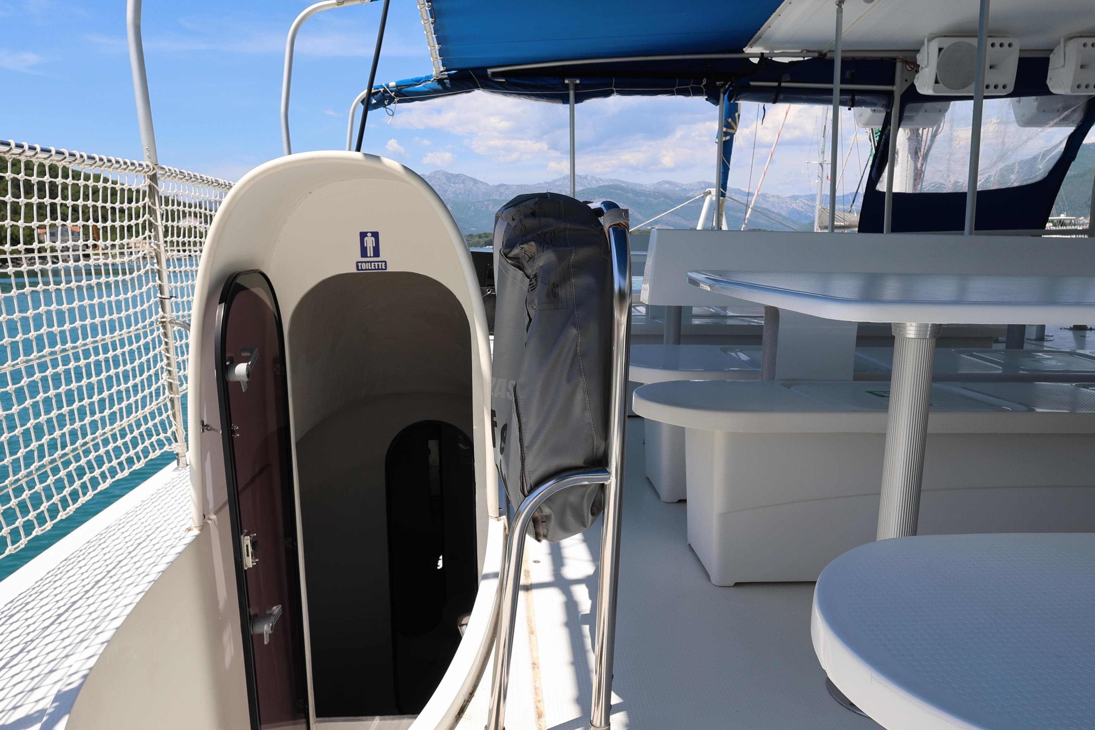 Fountaine Pajot Taiti Day Charter 80 deck with seating and restroom entrance, 2015 model.