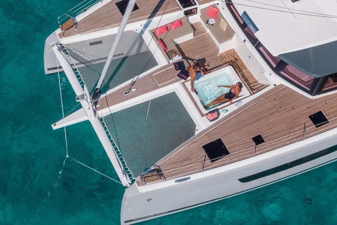 2024 Fountaine Pajot Alegria 67 Catamaran with jacuzzi, lounging area, and turquoise water.