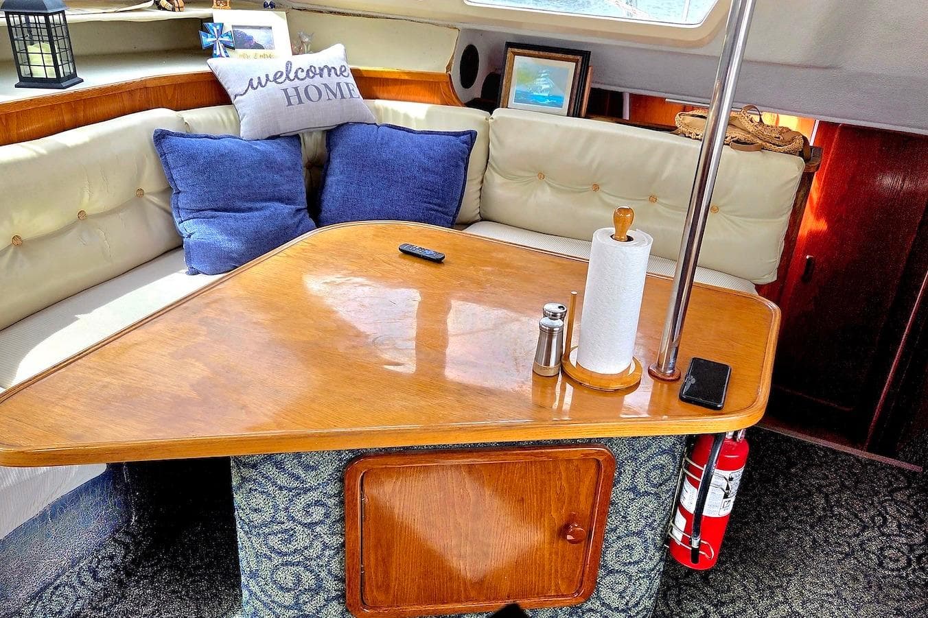 Cozy interior of 1995 Catamaran St. Francis 43 with cushions and wooden table.
