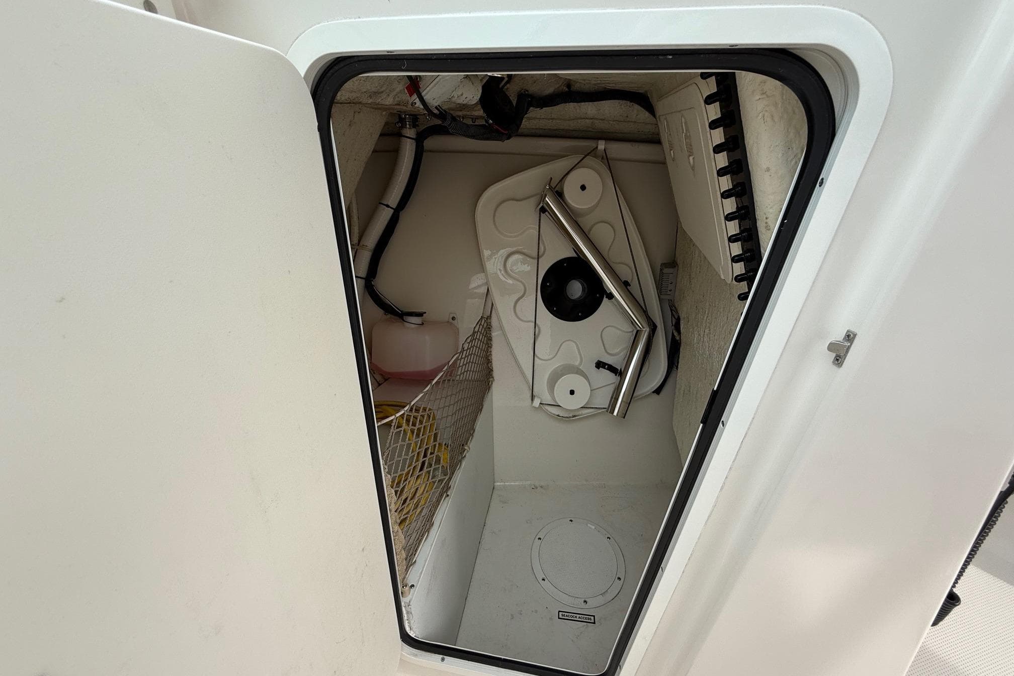 Storage compartment in 2019 Sailfish 275 DC boat, featuring organized interior and equipment.