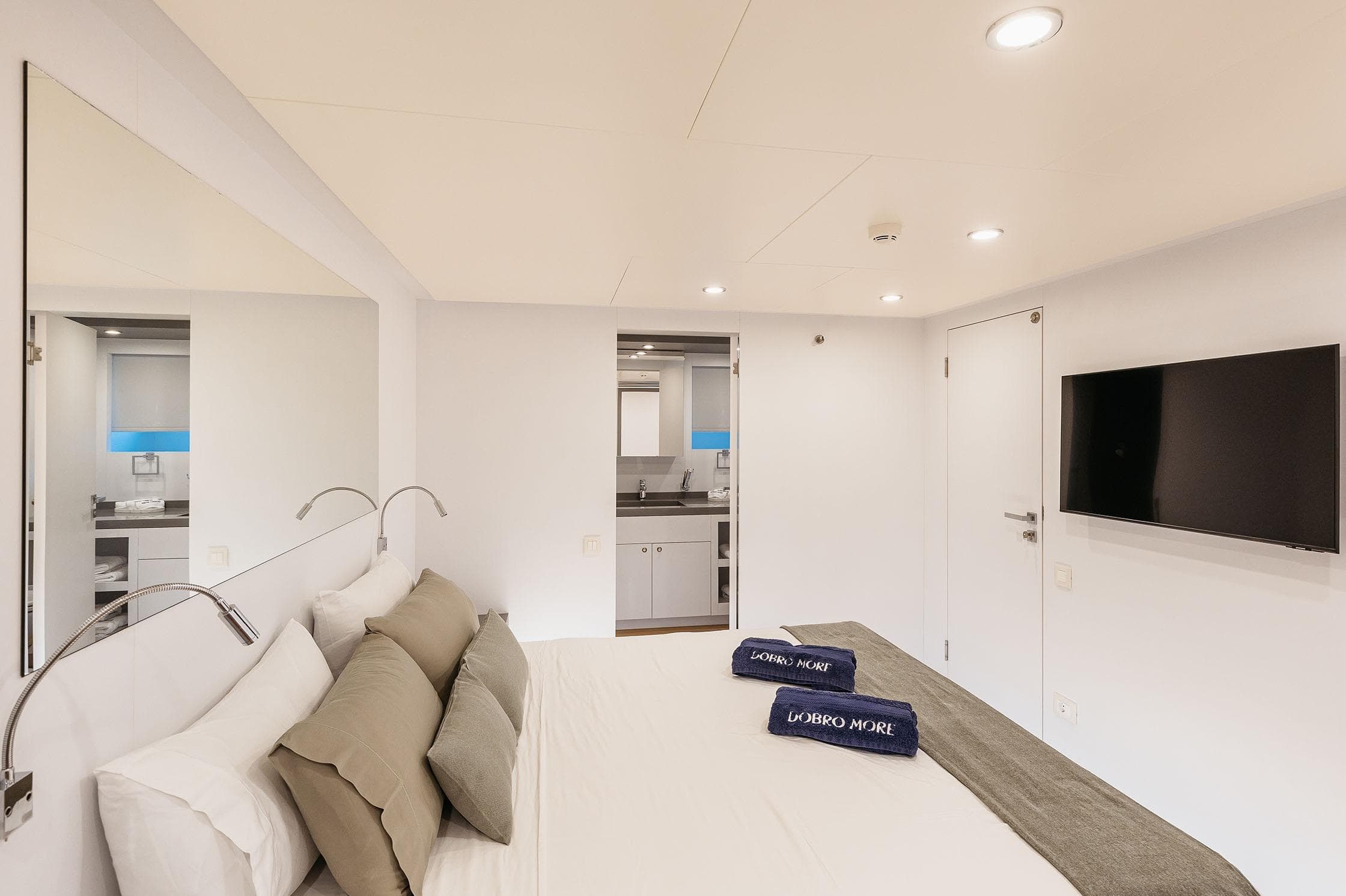 Luxurious bedroom in 2018 Arkin Pruva Argos Custom Explorer 27M yacht, featuring modern decor and amenities.