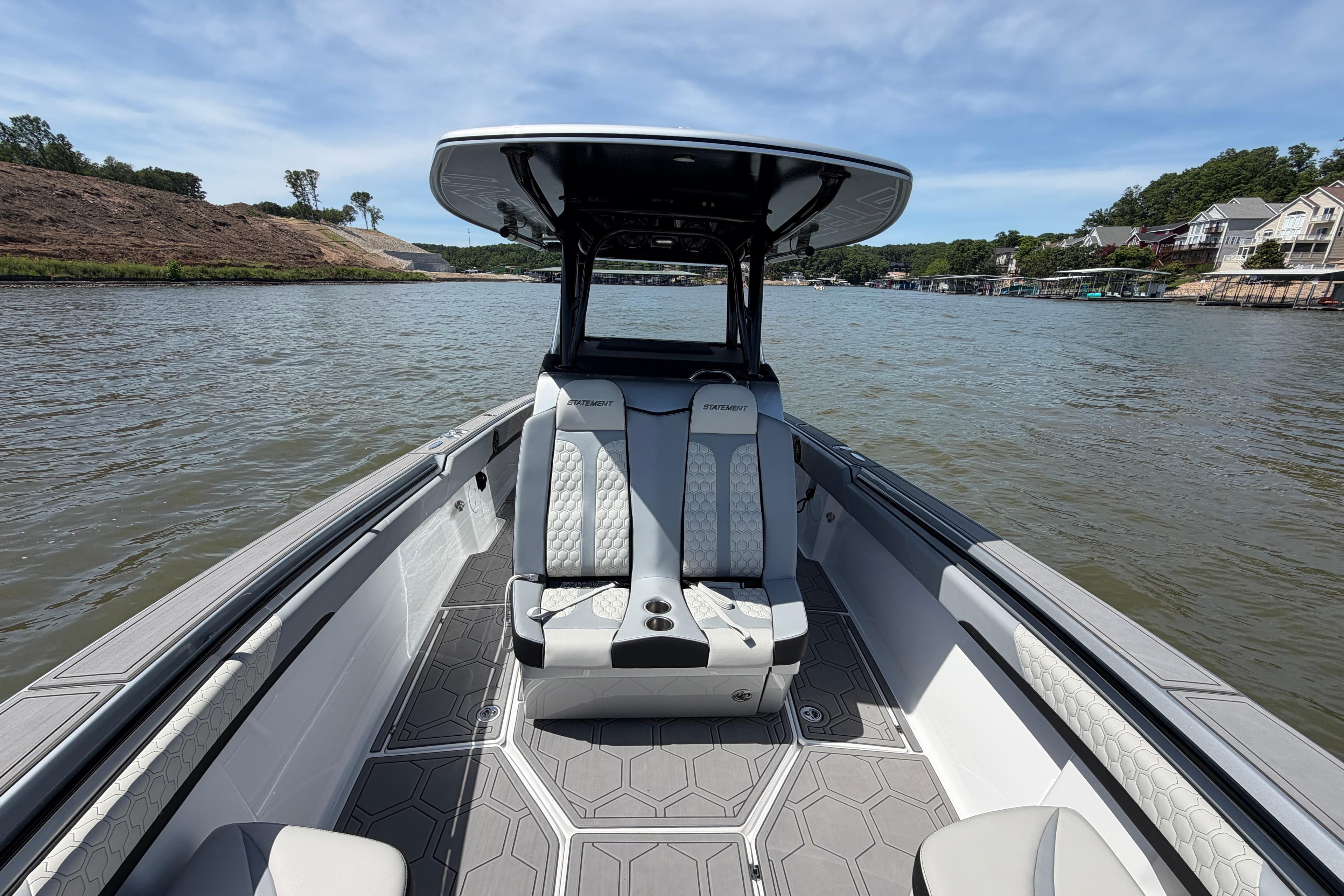 2024 Statement 350 Open boat on a scenic lake with modern seating and sleek design.
