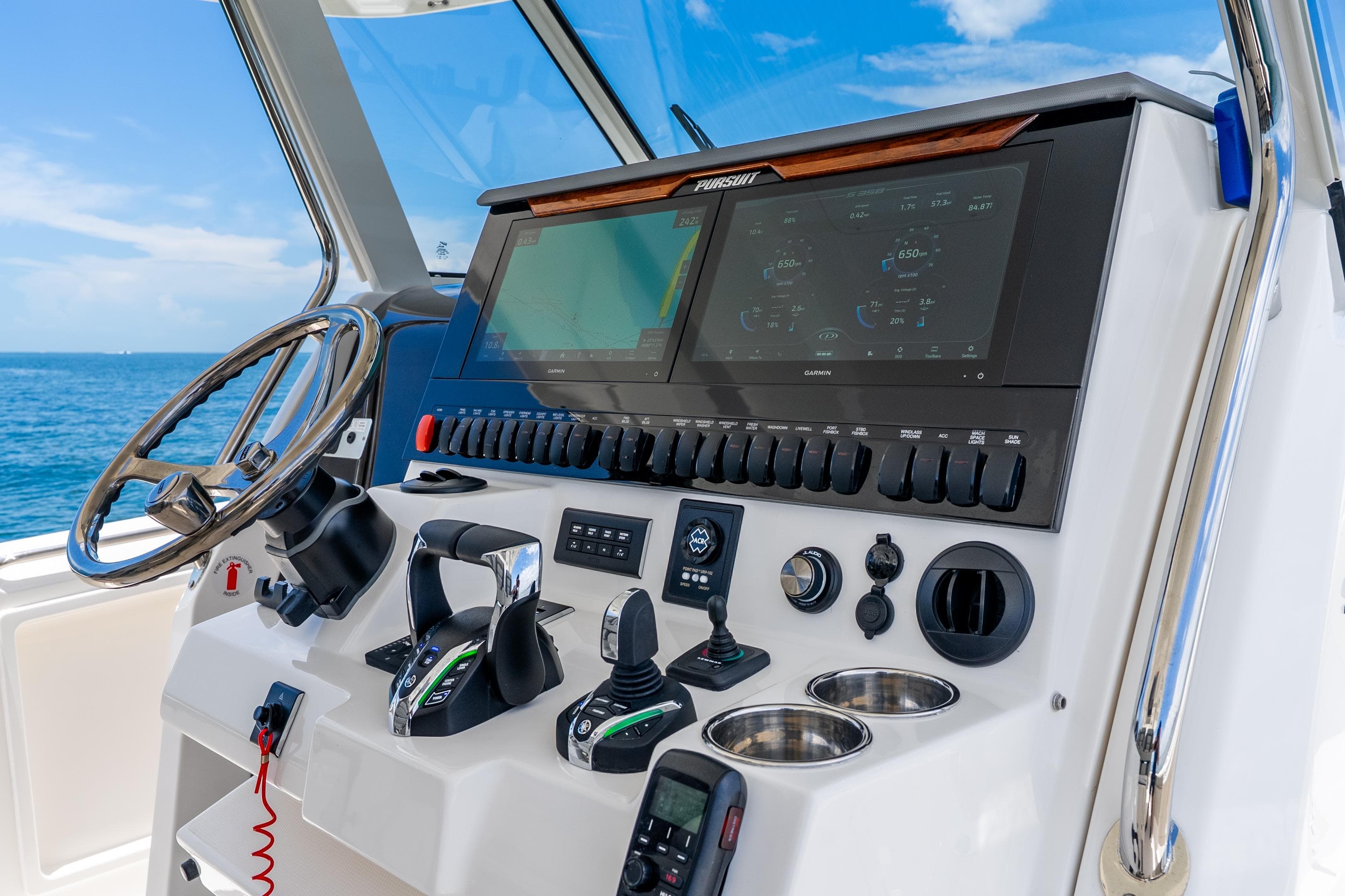Helm of 2026 Pursuit S 358 Sport boat with advanced controls and navigation system.