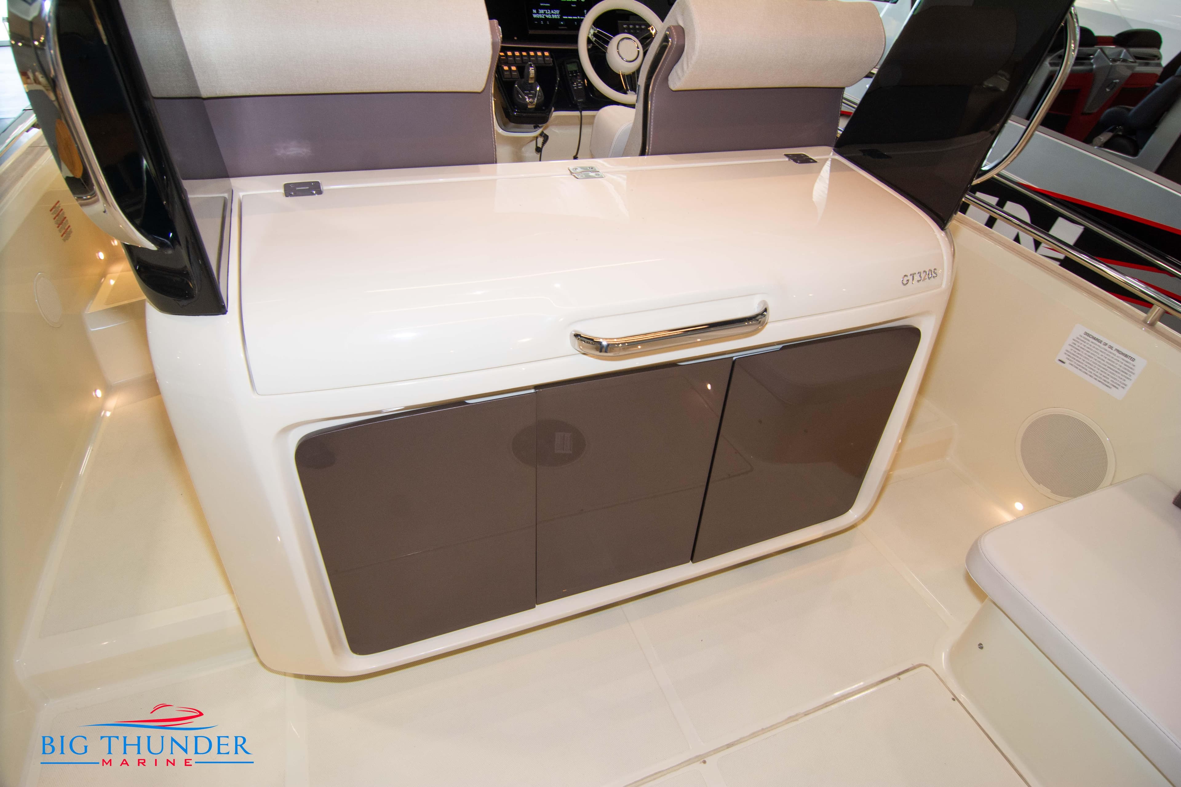 2024 Invictus GT320S boat interior with storage cabinets and seating, Big Thunder Marine logo.