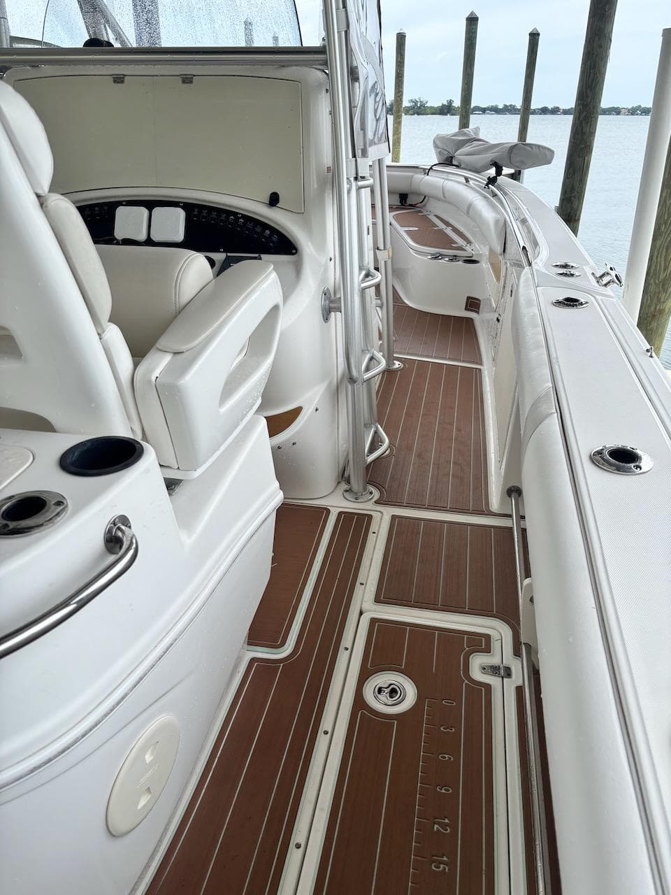 2006 Boston Whaler 320 Outrage boat interior with seating and wooden deck.