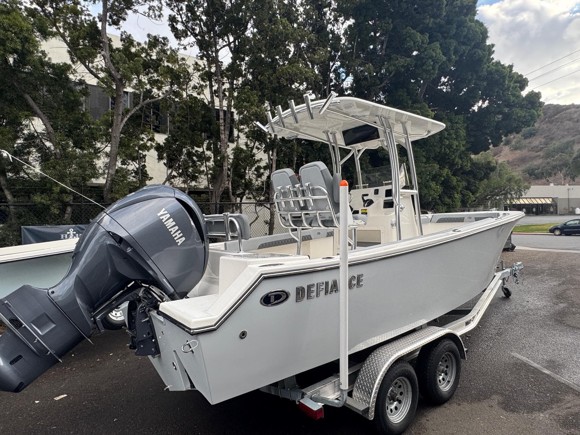 2025 Defiance Catalina 240 boat on trailer with Yamaha outboard motor, parked outdoors.