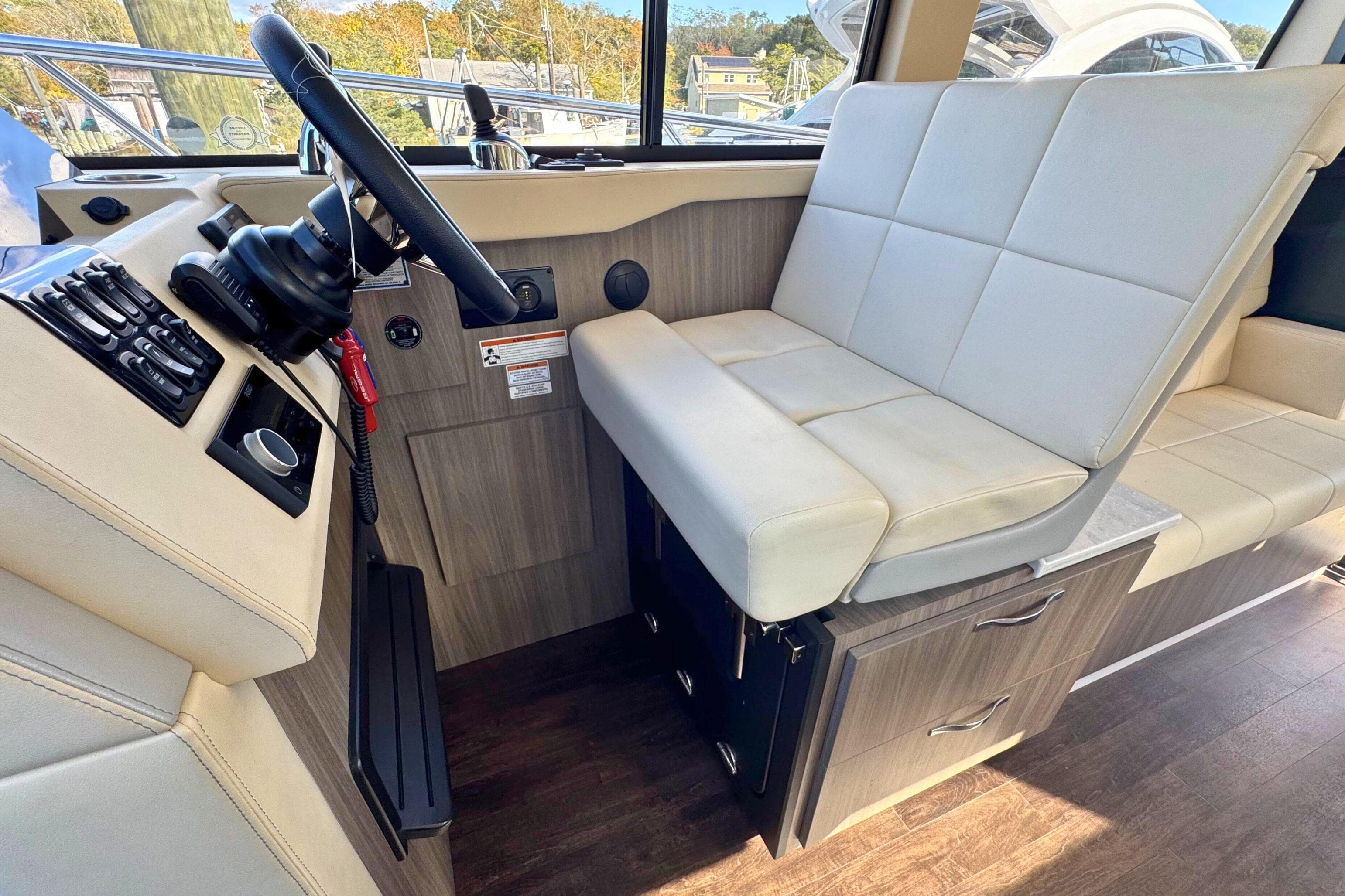 Interior of 2021 Regal 38 Grande Coupe with modern helm and seating area.
