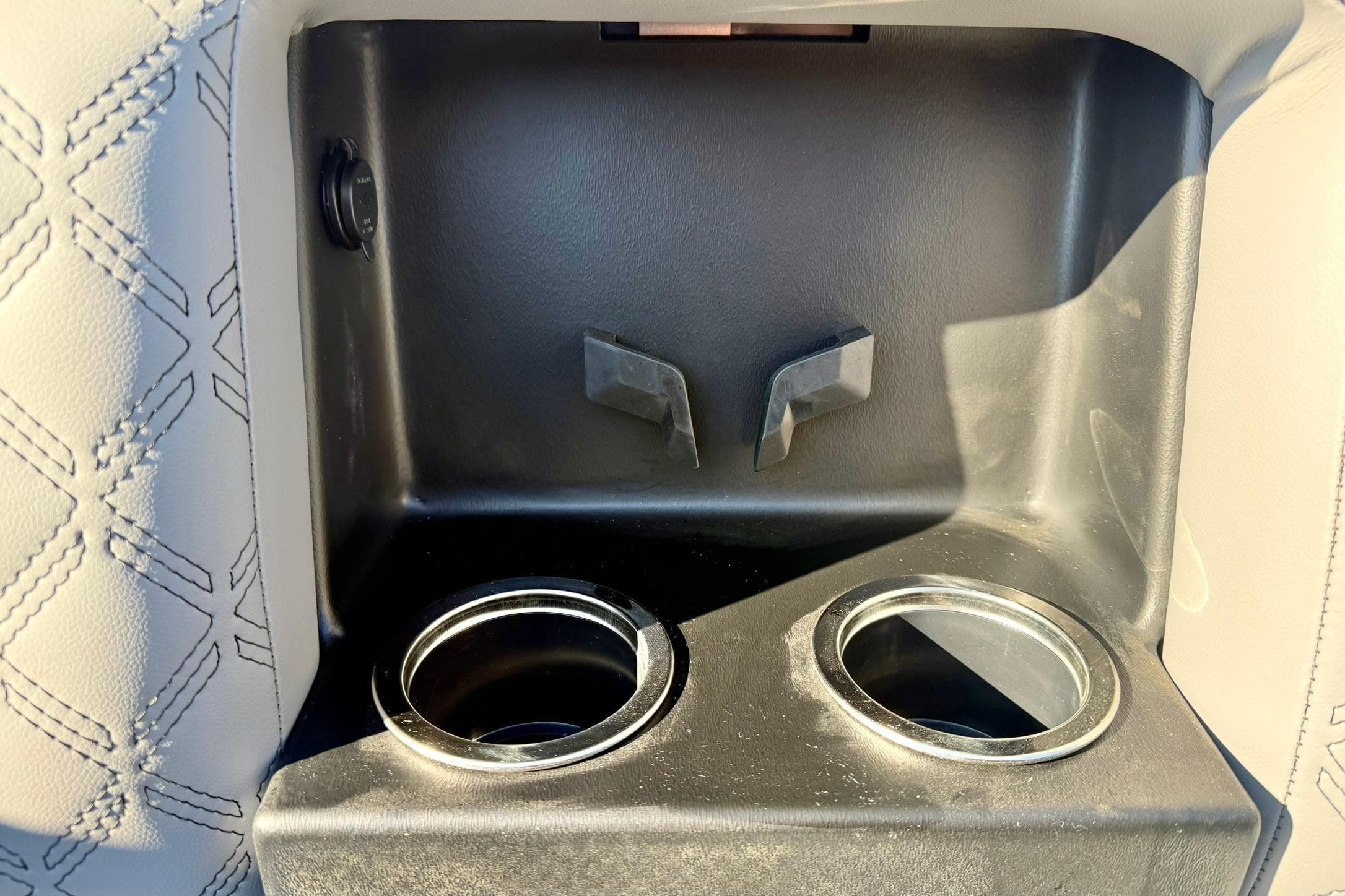 Cup holders and storage compartment in 2026 Crest Conquest 210 Fish boat interior.