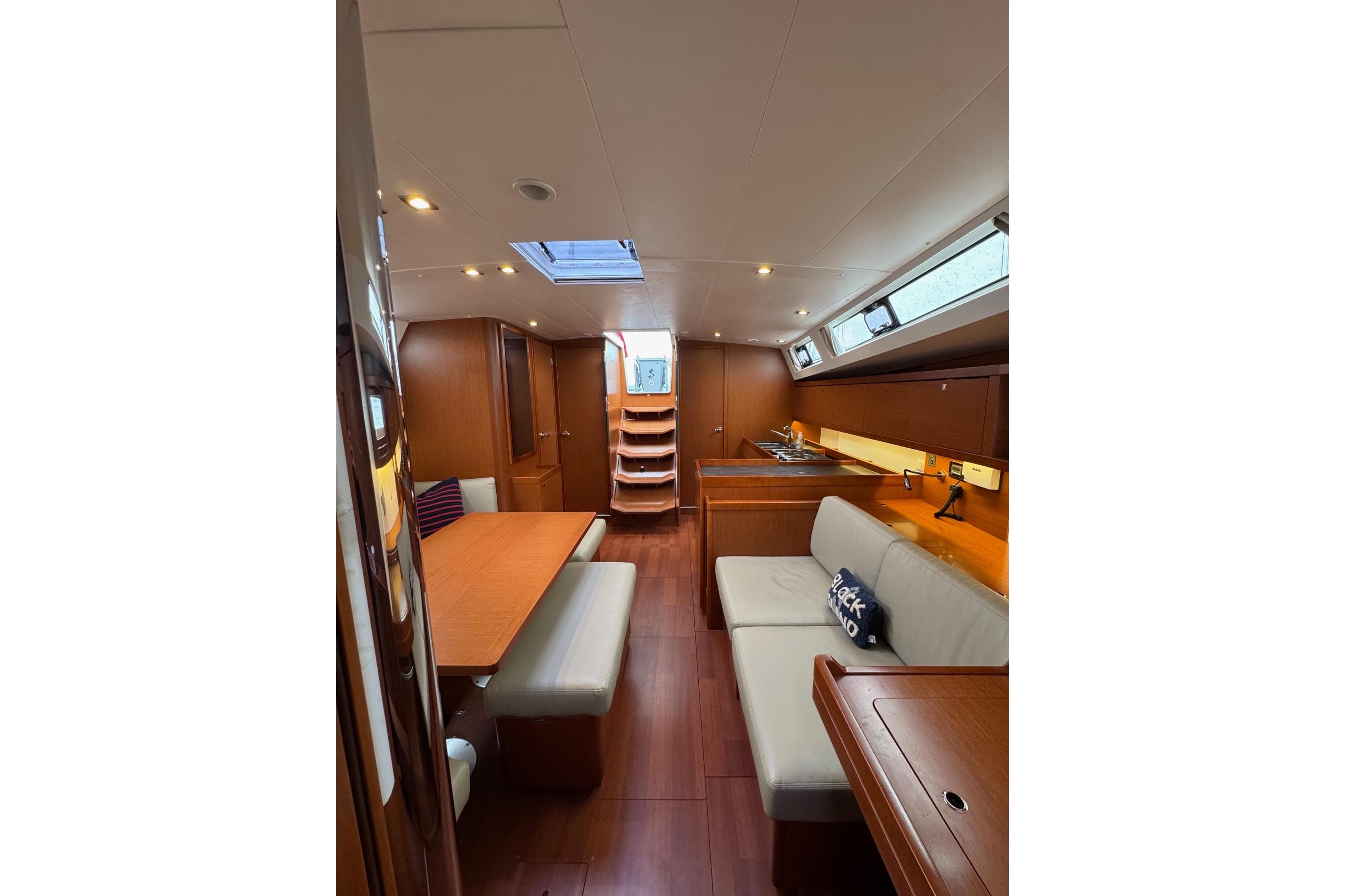 Interior of 2017 Beneteau Oceanis 45 yacht, featuring elegant wood finishes and modern seating.