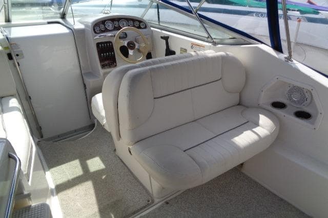 2006 Chaparral Signature 240 boat interior with steering wheel and cushioned seating.