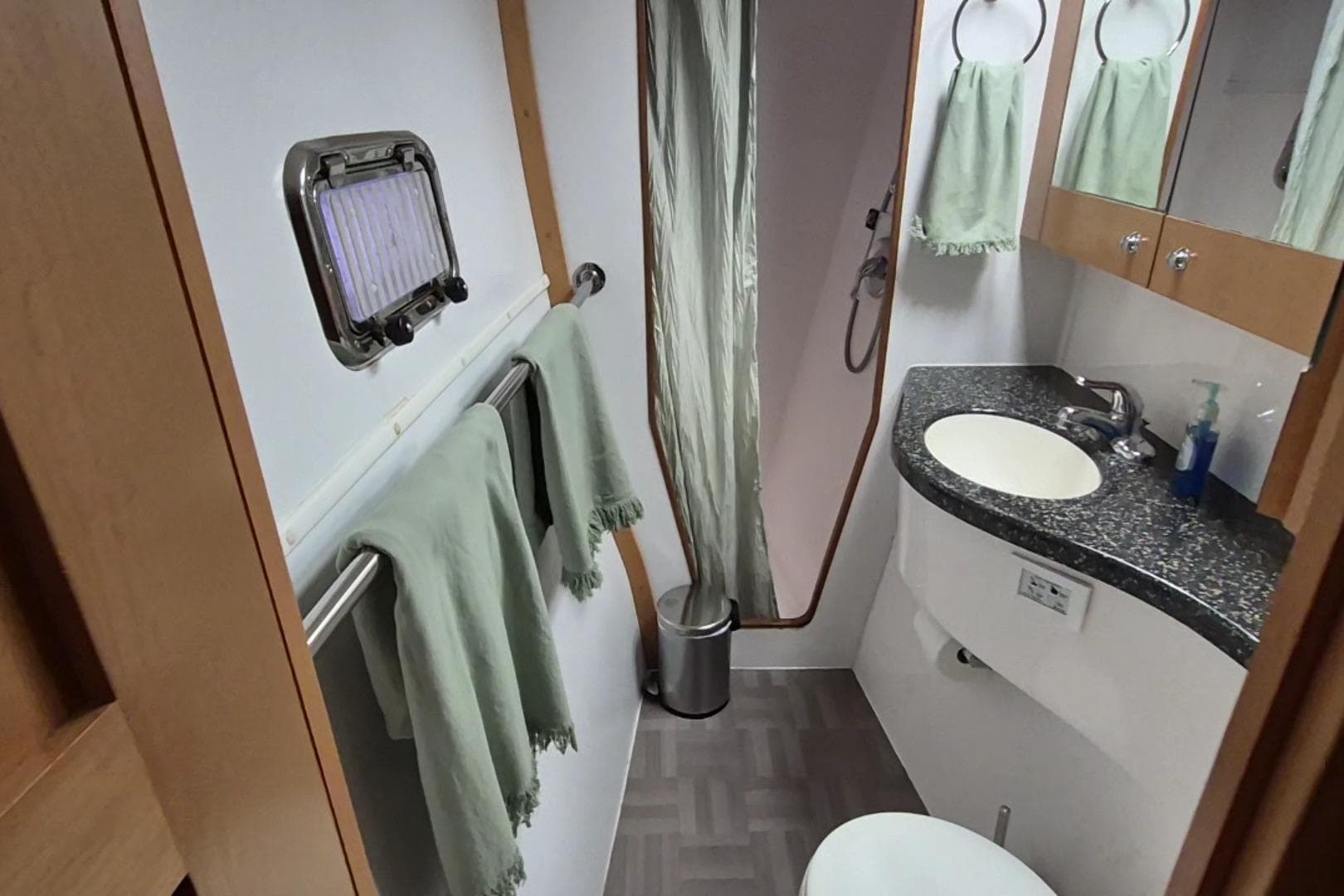 Bathroom interior of 2009 Endeavour 40 Skylounge yacht with sink, shower, and towels.