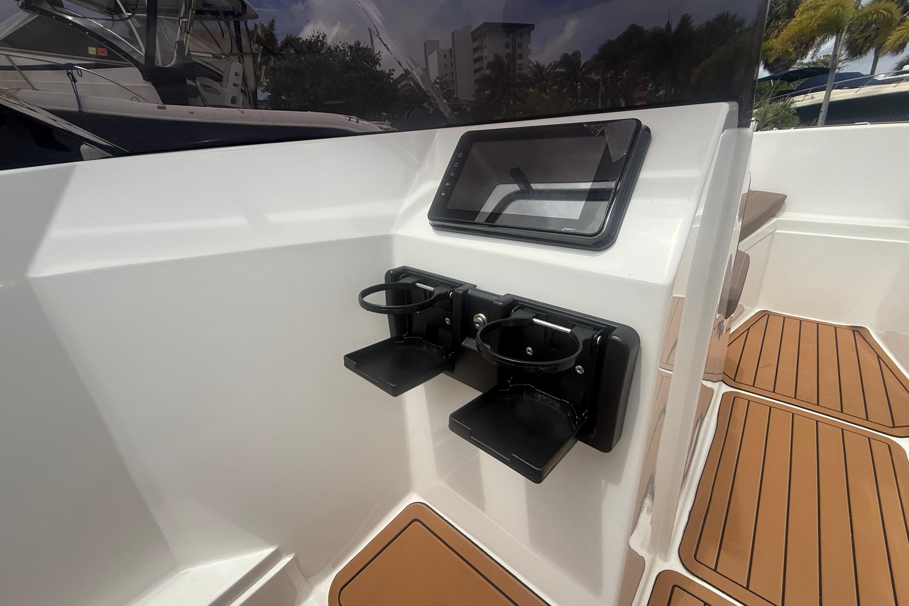 Interior of 2025 Drive Wave 570 boat with cup holders and touchscreen display.