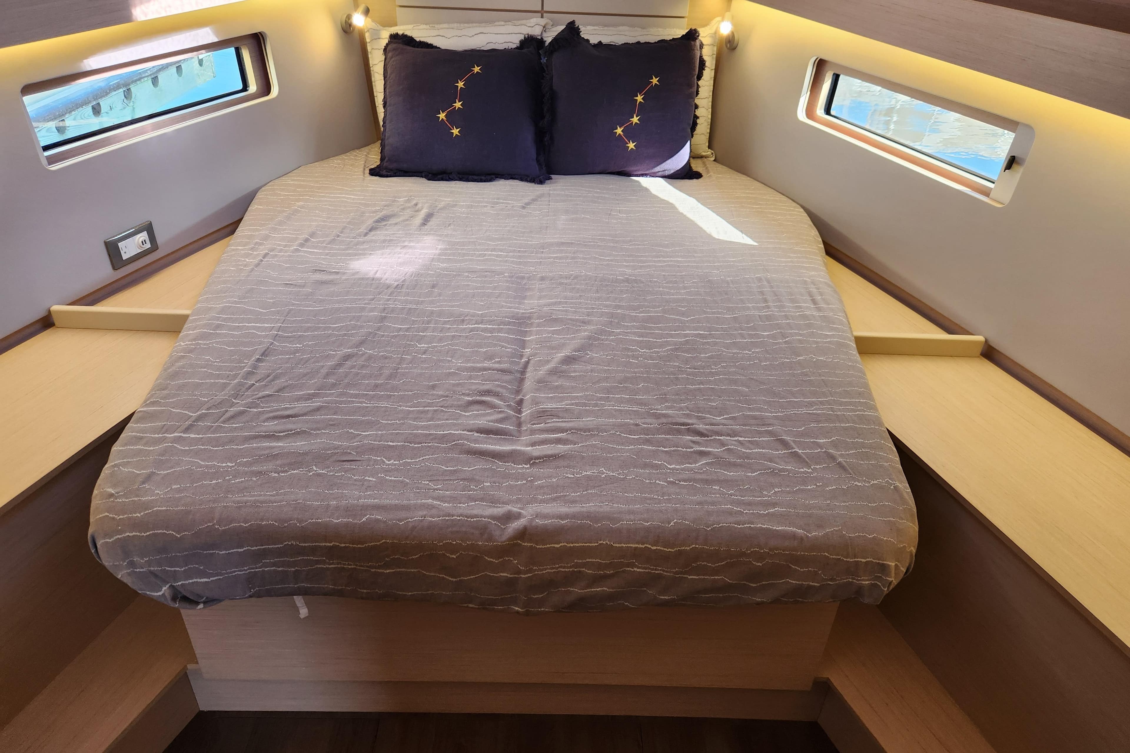 Cozy cabin interior of 2022 Beneteau Oceanis 40.1 with comfortable bed and ambient lighting.