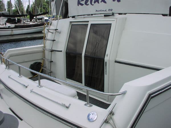 1991 Carver 430 Cockpit Motor Yacht with sliding doors and ladder, docked in Portland, OR.