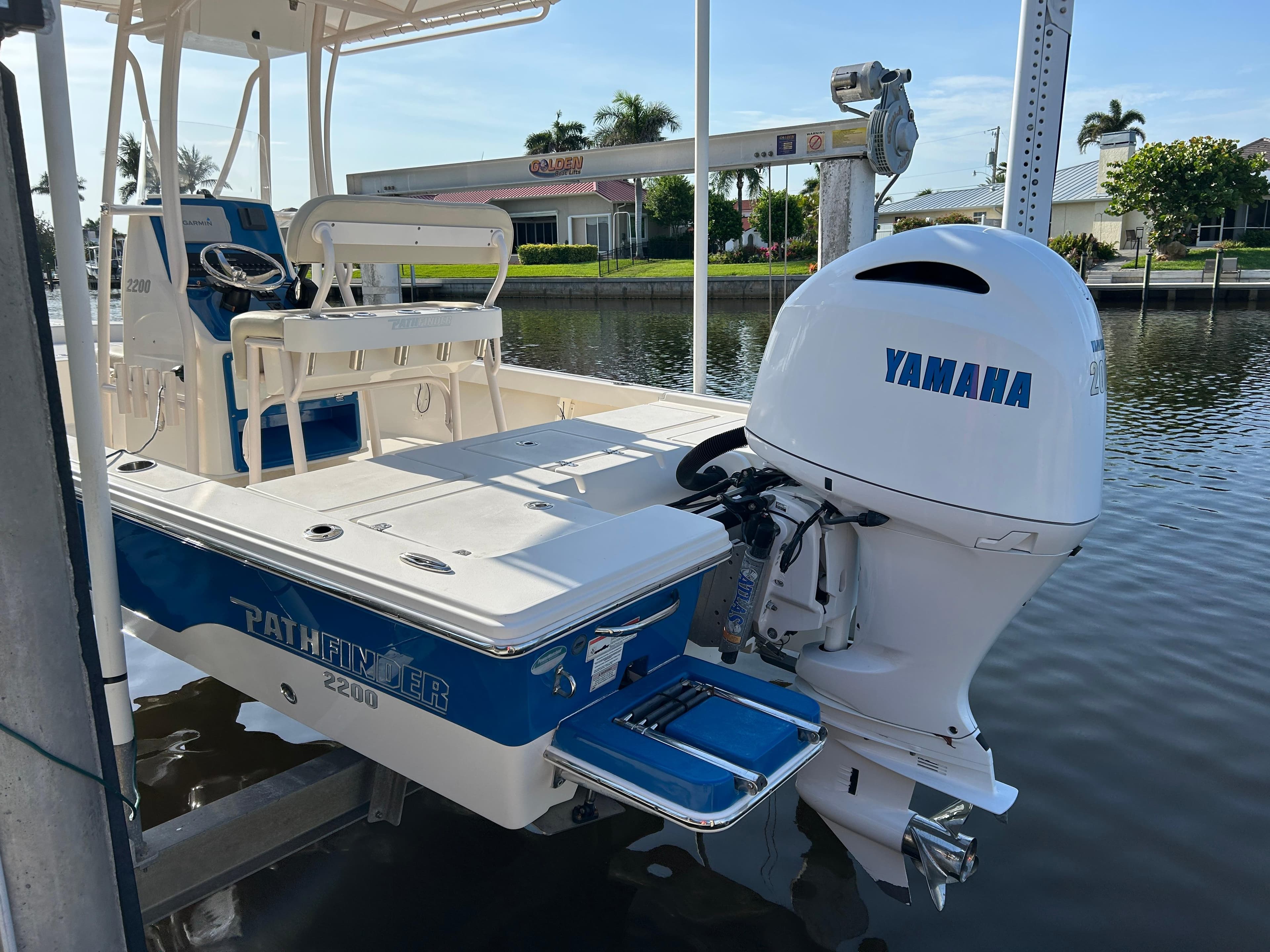 2019 Pathfinder 2200 CC boat with Yamaha outboard motor docked by the water.