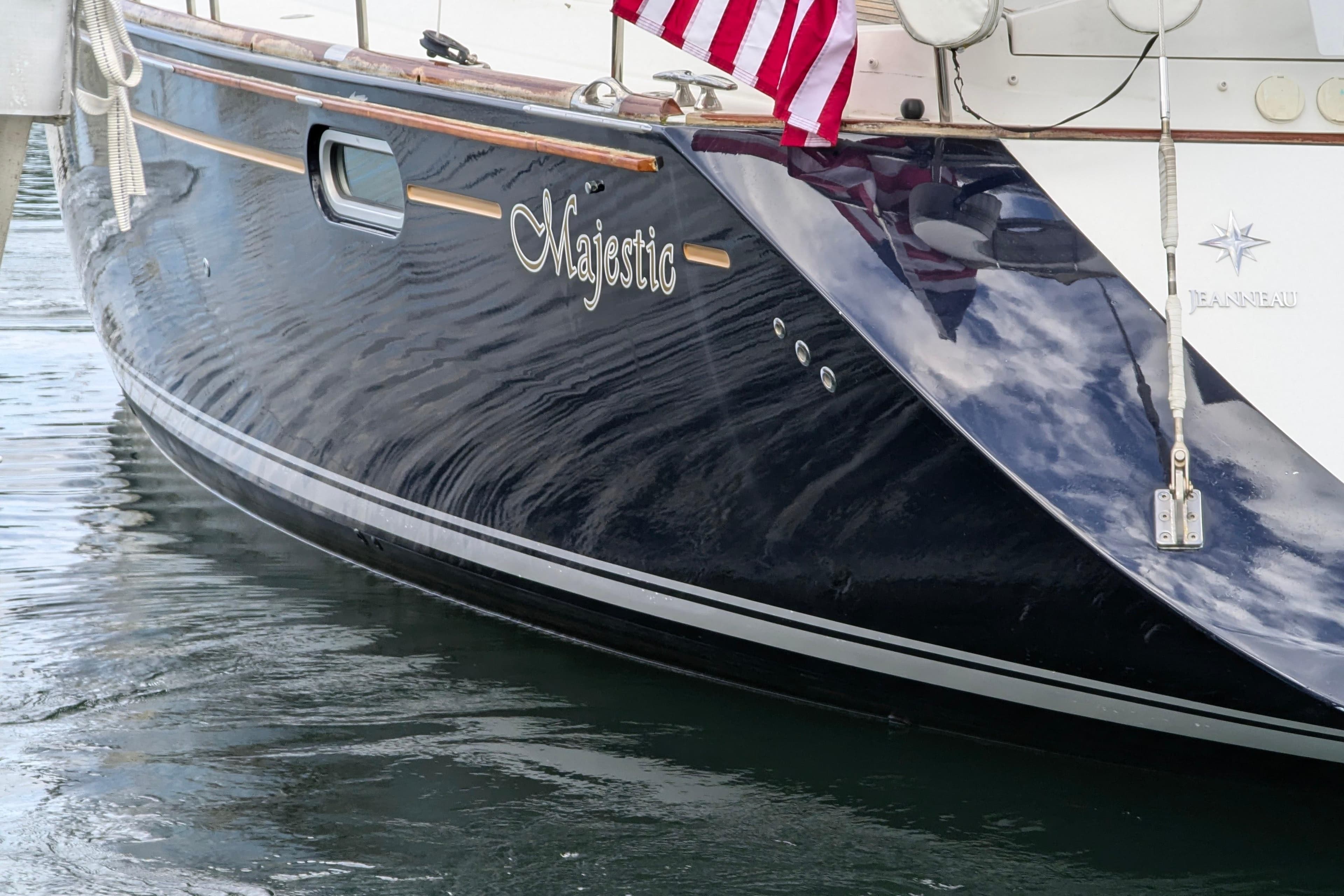 Jeanneau Sun Odyssey 54 DS yacht, 2009 model, docked with American flag.