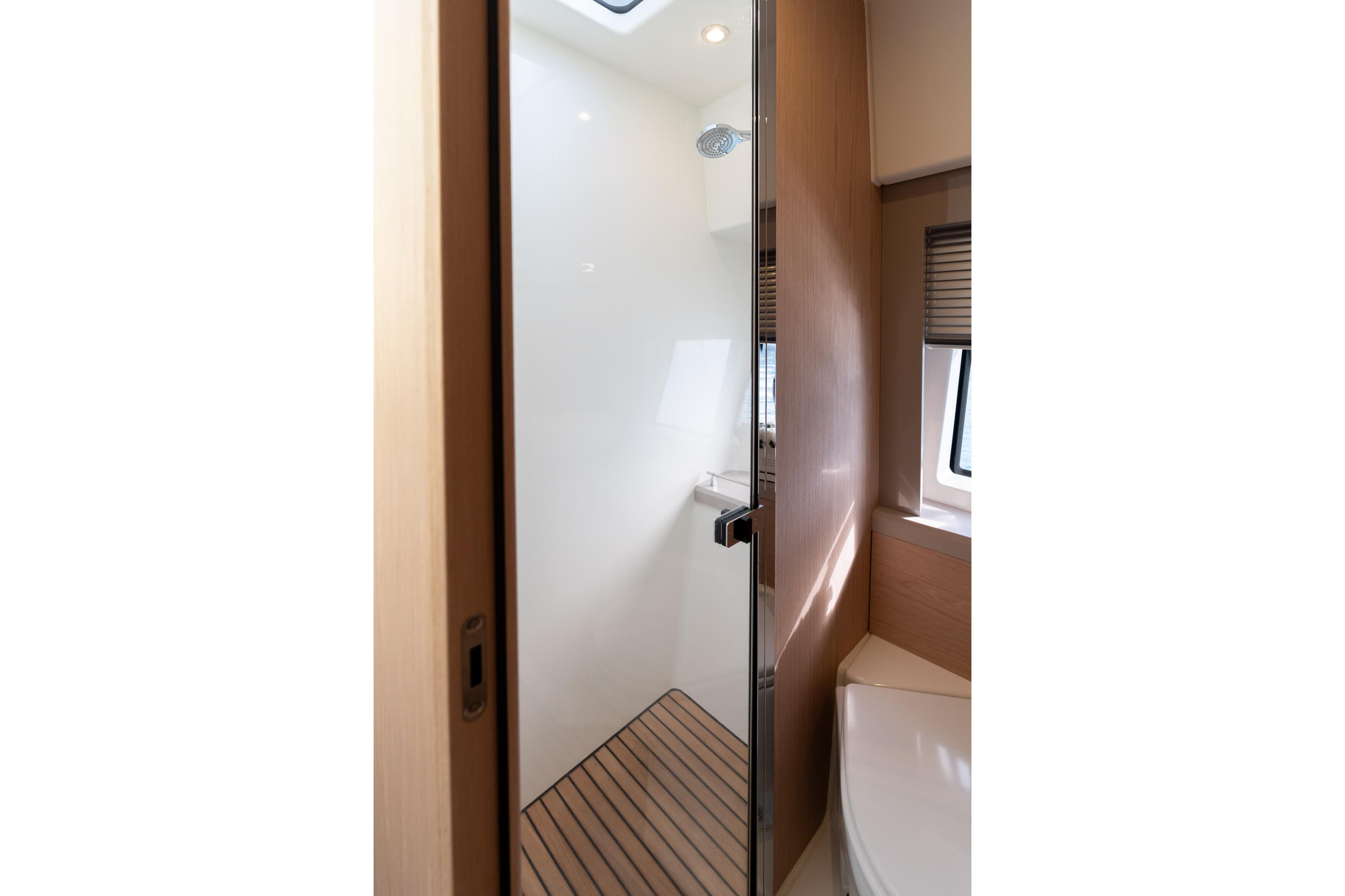 Luxurious bathroom interior of 2022 Monte Carlo 52 yacht with modern shower design.