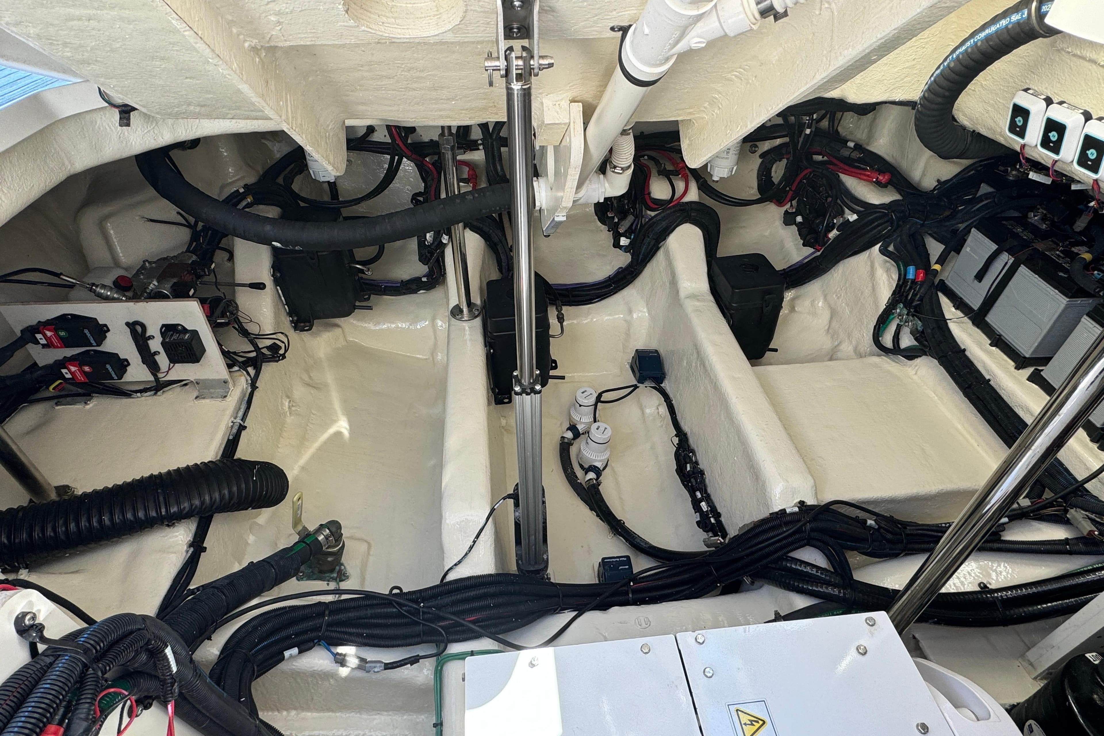 Engine compartment of 2022 Sea Ray SLX 400 Outboard, showcasing wiring and components.