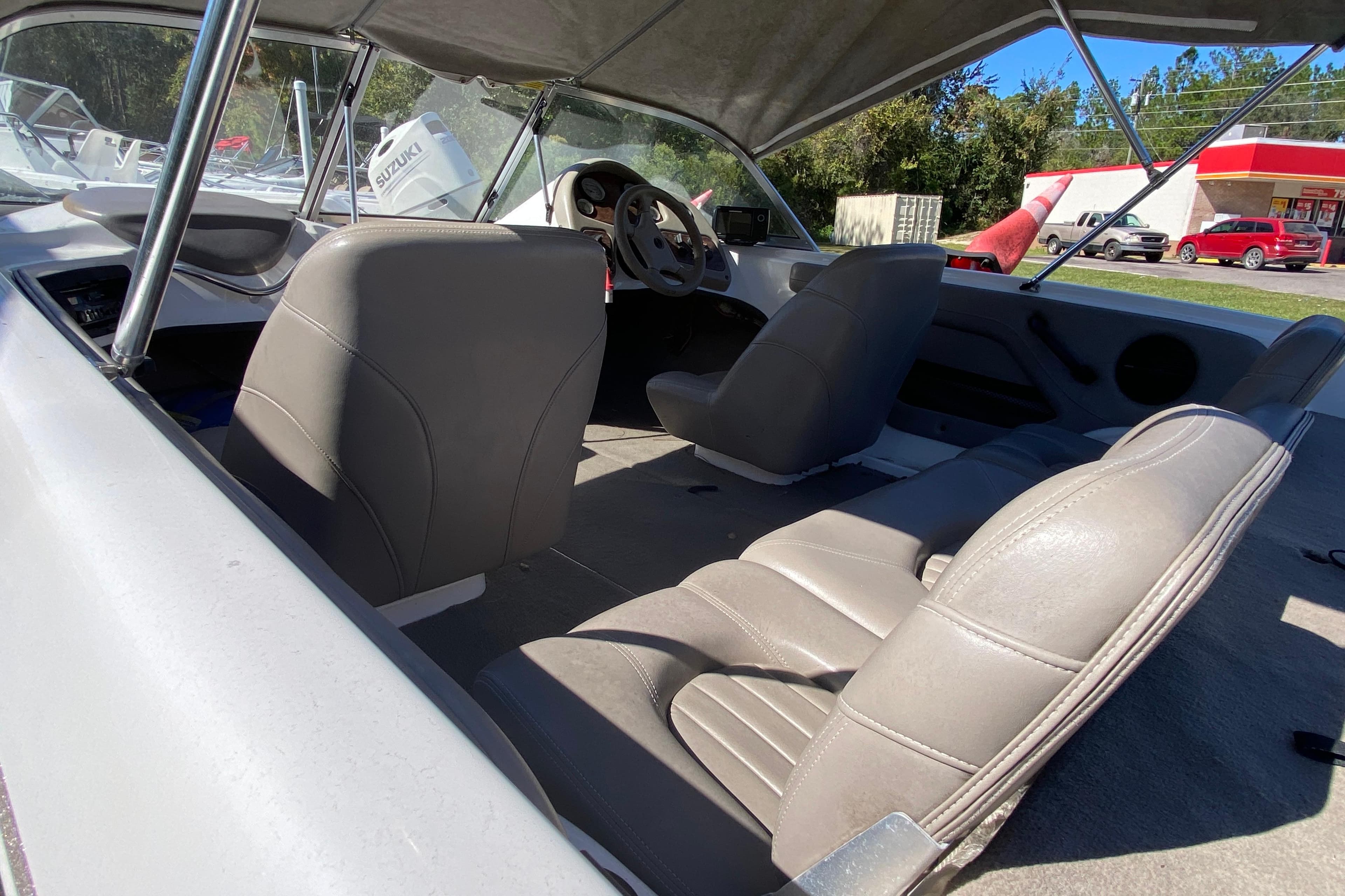 Interior of 2001 ProCraft 180 Combo boat with gray seating and steering wheel.