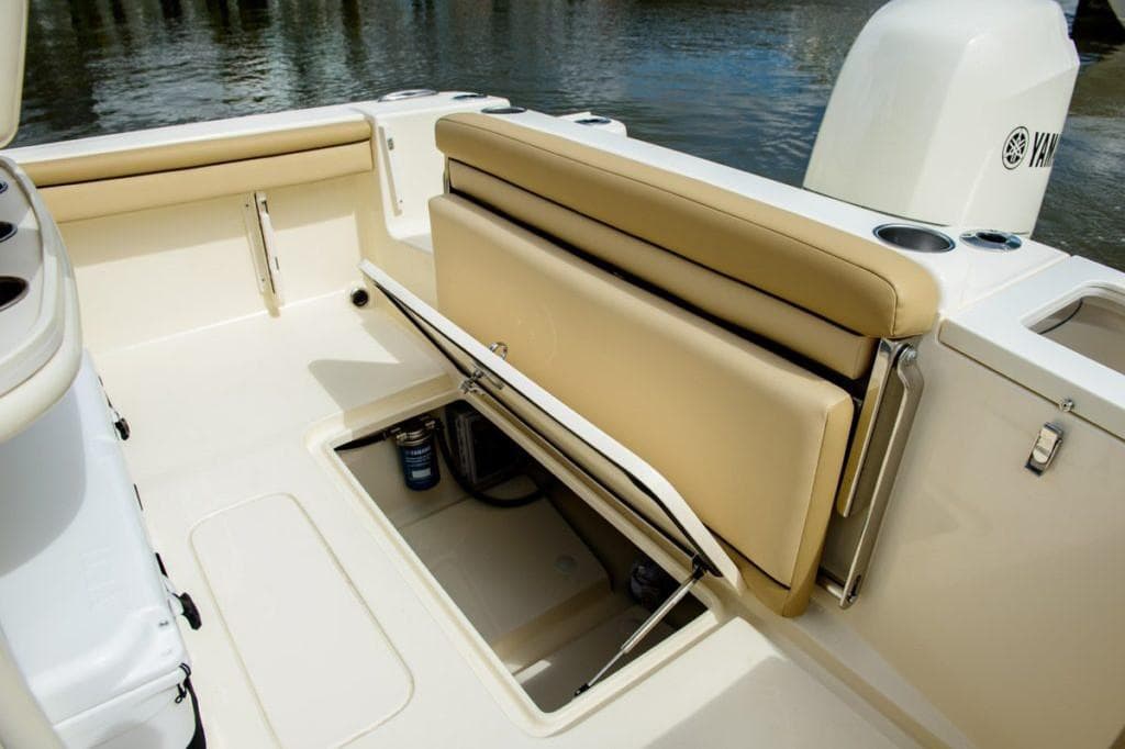 Manufacturer Provided Image: 2025 Scout 215 XSF boat interior with tan seating and storage compartment.
