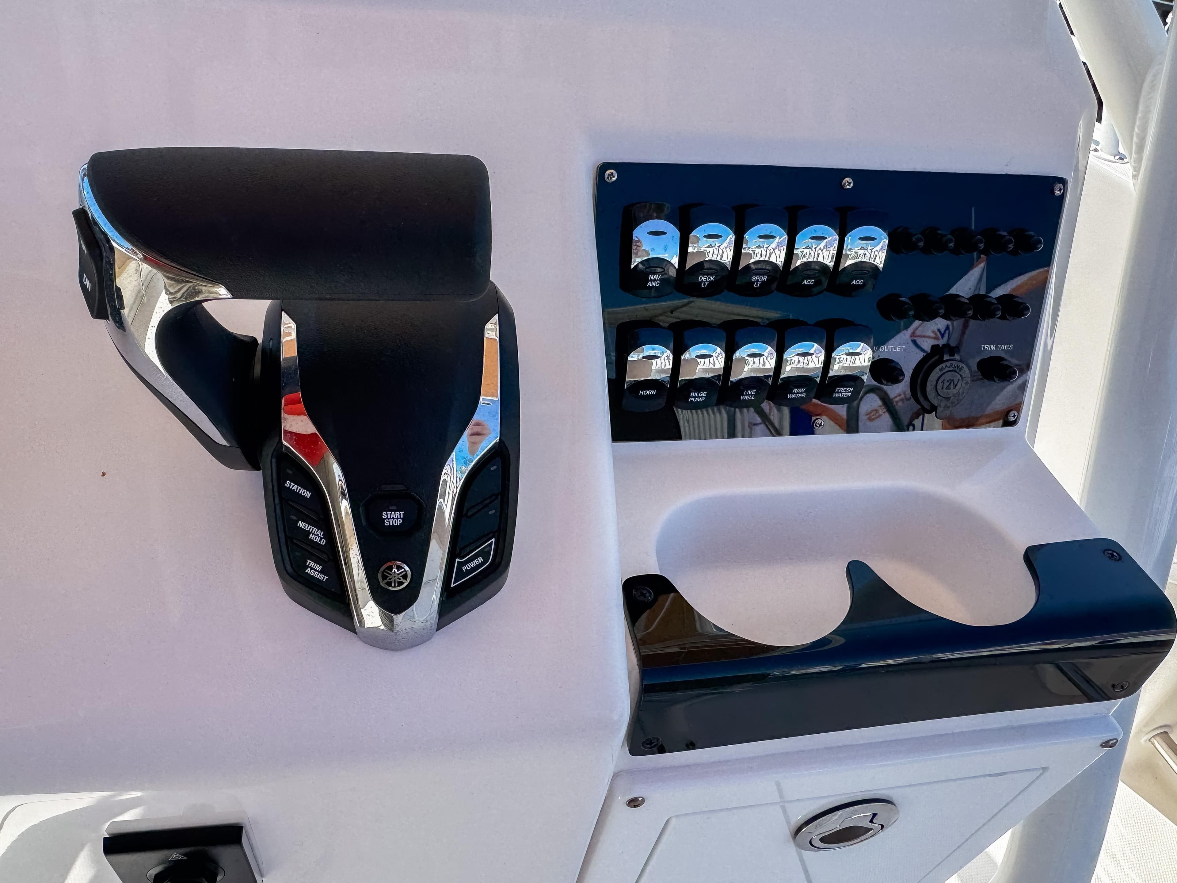 Edgewater 208CC 2025 boat control panel with throttle and switches.