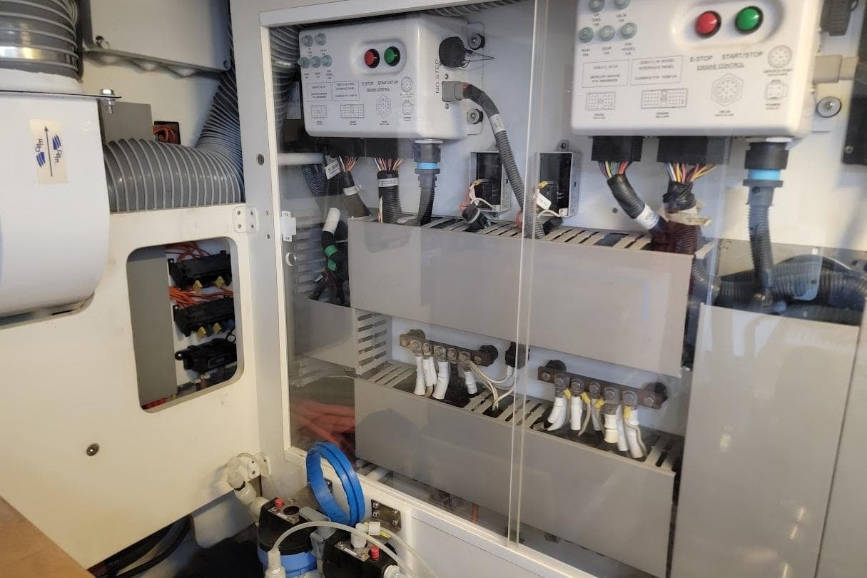 Electrical panel inside a 2014 Prestige 550 yacht, showcasing wiring and control systems.
